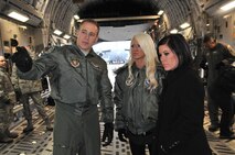 Senior Airman Kyle Knox (left), 446th Aeromedical Evacuation Squadron medical technician, McChord Field, Wash., explains the critical aeromedical evacuation Reserve mission to Total Nonstop Action wrestlers Angelina Love (center) and Madison Rayne, who stopped by, Dec. 6, 2011 to meet and greet the troops of JBLM and tour a C-17 Globemaster III. Rayne's husband is an active-duty Airman (U.S. Air Force photo/2nd. Lt. Denise Hauser) 