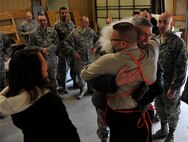 MINOT AIR FORCE BASE, N.D. – Colonel Gerald McManus, Air Force Global Strike Command chaplain, shares an embrace with Milt Arneson, Home Depot executive, during Operation Homefront here Dec. 15. Operation Homefront and the Home Depot Foundation in coordination with Minot AFB’s Operation Warmheart and General Electric distributed 135 appliances to Team Minot Airmen and their families affected by the historic Souris River flood. (U.S. Air Force photo/Senior Airman Desiree Esposito)