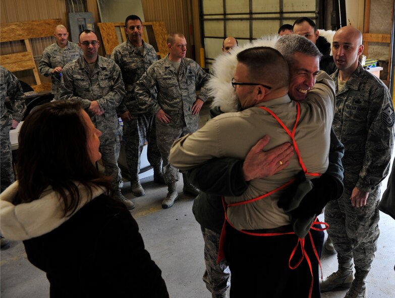 MINOT AIR FORCE BASE, N.D. – Colonel Gerald McManus, Air Force Global Strike Command chaplain, shares an embrace with Milt Arneson, Home Depot executive, during Operation Homefront here Dec. 15. Operation Homefront and the Home Depot Foundation in coordination with Minot AFB’s Operation Warmheart and General Electric distributed 135 appliances to Team Minot Airmen and their families affected by the historic Souris River flood. (U.S. Air Force photo/Senior Airman Desiree Esposito)