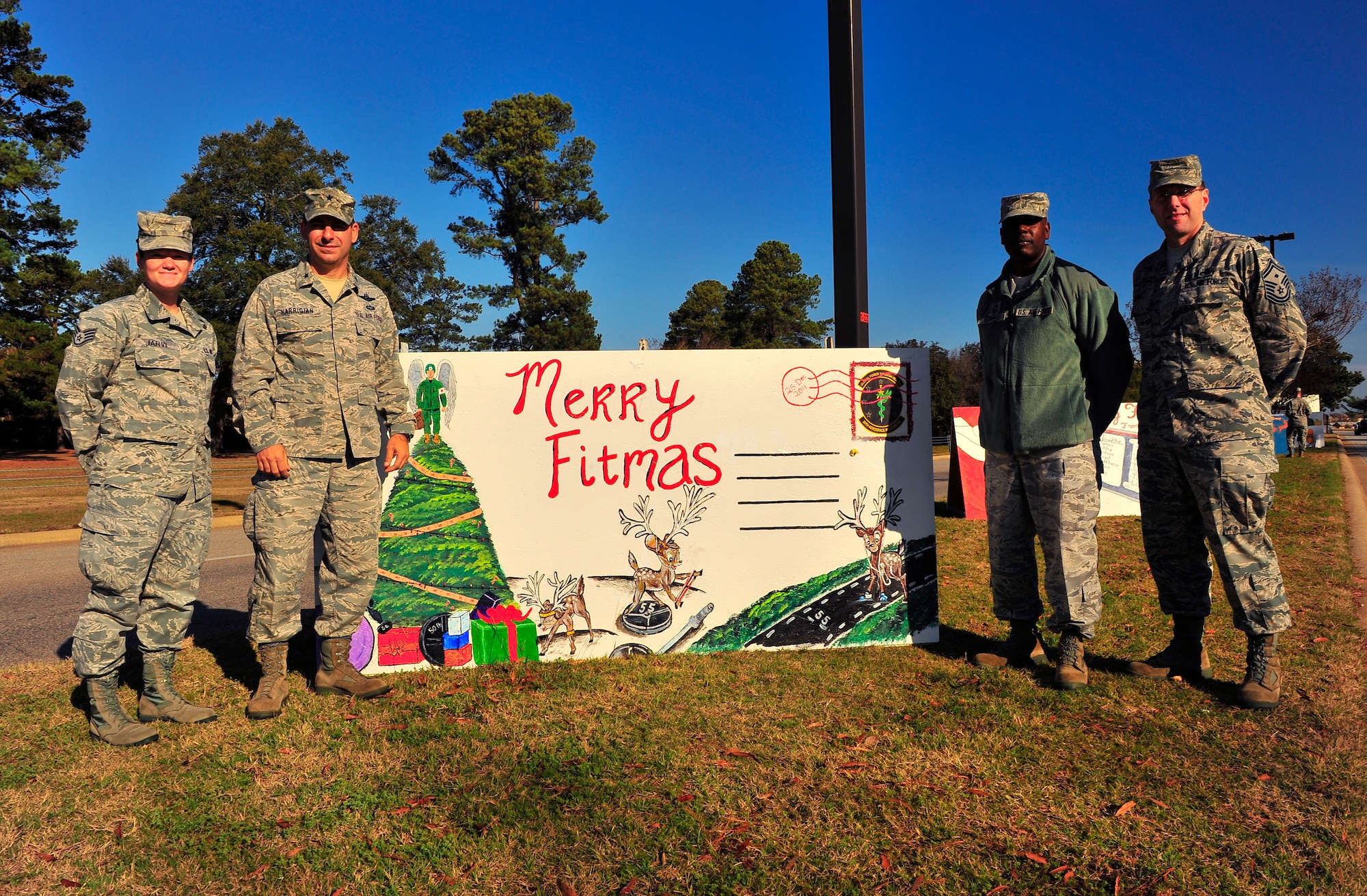 U.S. Air Force (from left) Staff Sgt. Elina Jarvi, 20th Aerospace Medical Squadron administrative technician, Brig. Gen. Jeffery Harrigian, Air Force Central Command assistant deputy commander, Chief Master Sgt. Robert Forest, 20th Medical Group superintendent, and Lt. Col. John Vickrey, 20th Communications Squadron commander, pose with the holiday card from the 20th AMDS, Dec. 15, 2011, Shaw Air Force Base, S.C. The holiday cards were created for seasonal spirit and squadron competition. (U.S. Air Force photo by Airman 1st Class Neil D. Warner)