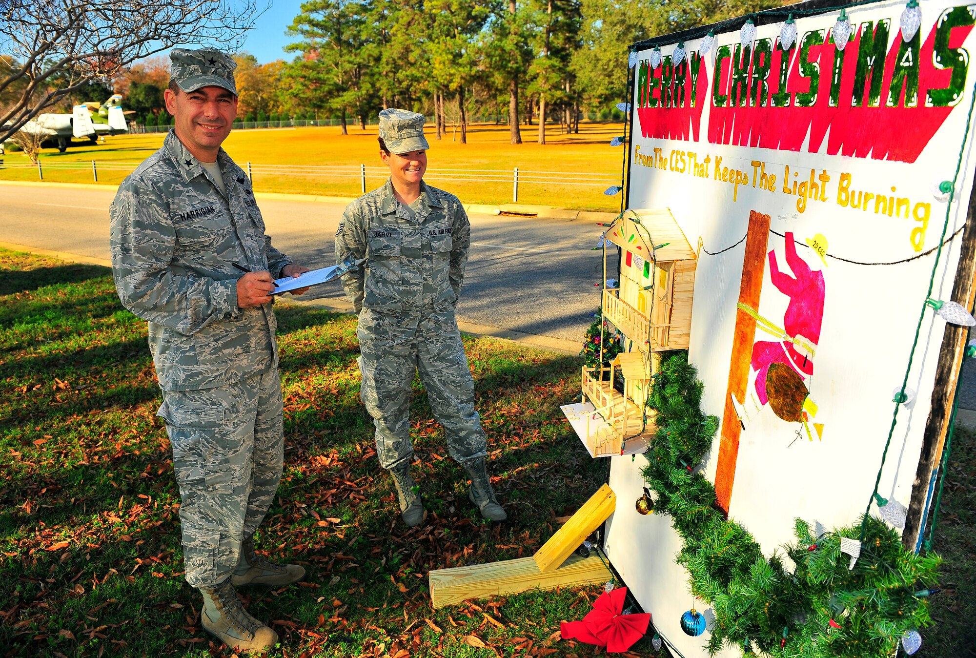 U.S. Air Force Brig. Gen. Jeffery Harrigian, Air Force Central Command assistant deputy commander, judges cards with Staff Sgt. Elina Jarvi, 20th Aerospace Medical squadron administrative technician, Dec. 15, 2011, Shaw Air Force Base, S.C. The holiday cards were created for seasonal spirit and squadron competition. (U.S. Air Force photo by Airman 1st Class Neil D. Warner)