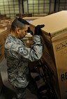 MINOT AIR FORCE BASE, N.D. – Master Sgt. Christopher Owen, 91st Operations Group first sergeant, retrieves a refrigerator for a family in need during Operation Homefront here Dec. 15. Operation Homefront was a charitable initiative headed by the Home Depot Foundation, in coordination with Minot AFB’s Operation Warm Heart and General Electric, which donated more than 130 appliances to Team Minot Airmen and their families affected by the historic Souris River flood. (U.S. Air Force photo/Senior Airman Desiree Esposito)