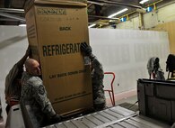 MINOT AIR FORCE BASE, N.D. – Master Sgt. Jesse Evans, 5th Operations Group first sergeant, assist with loading a donated refrigerator for a family in need during Operation Homefront here Dec. 15. Operation Homefront and the Home Depot Foundation in coordination with Minot AFB’s Operation Warmheart and General Electric distributed 135 appliances to Team Minot Airmen and their families affected by the historic Souris River flood. (U.S. Air Force photo/Senior Airman Desiree Esposito)