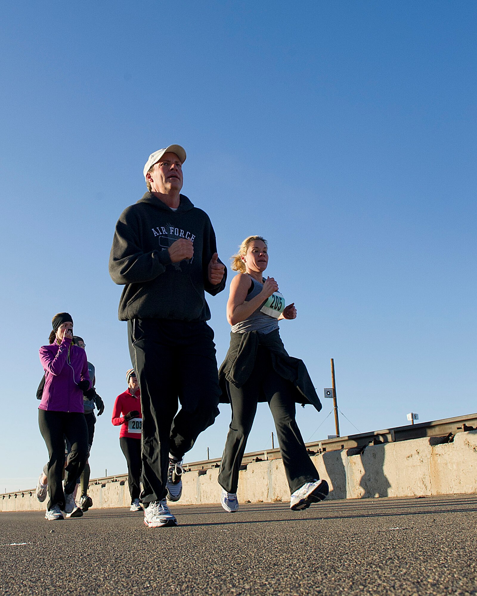HOLLOMAN AIR FORCE BASE, N.M. -- Participants in the High Speed Test Track Mach 10K approach the halfway mark of the 10 km race Dec. 9, 2011, at the Holloman High Speed Test Track. The event, hosted by the 846th Test Squadron, offered Team Holloman runners a 5 km, 10 km and 10-mile race. (U.S. Air Force photo by Senior Airman DeAndre Curtiss / Released)
