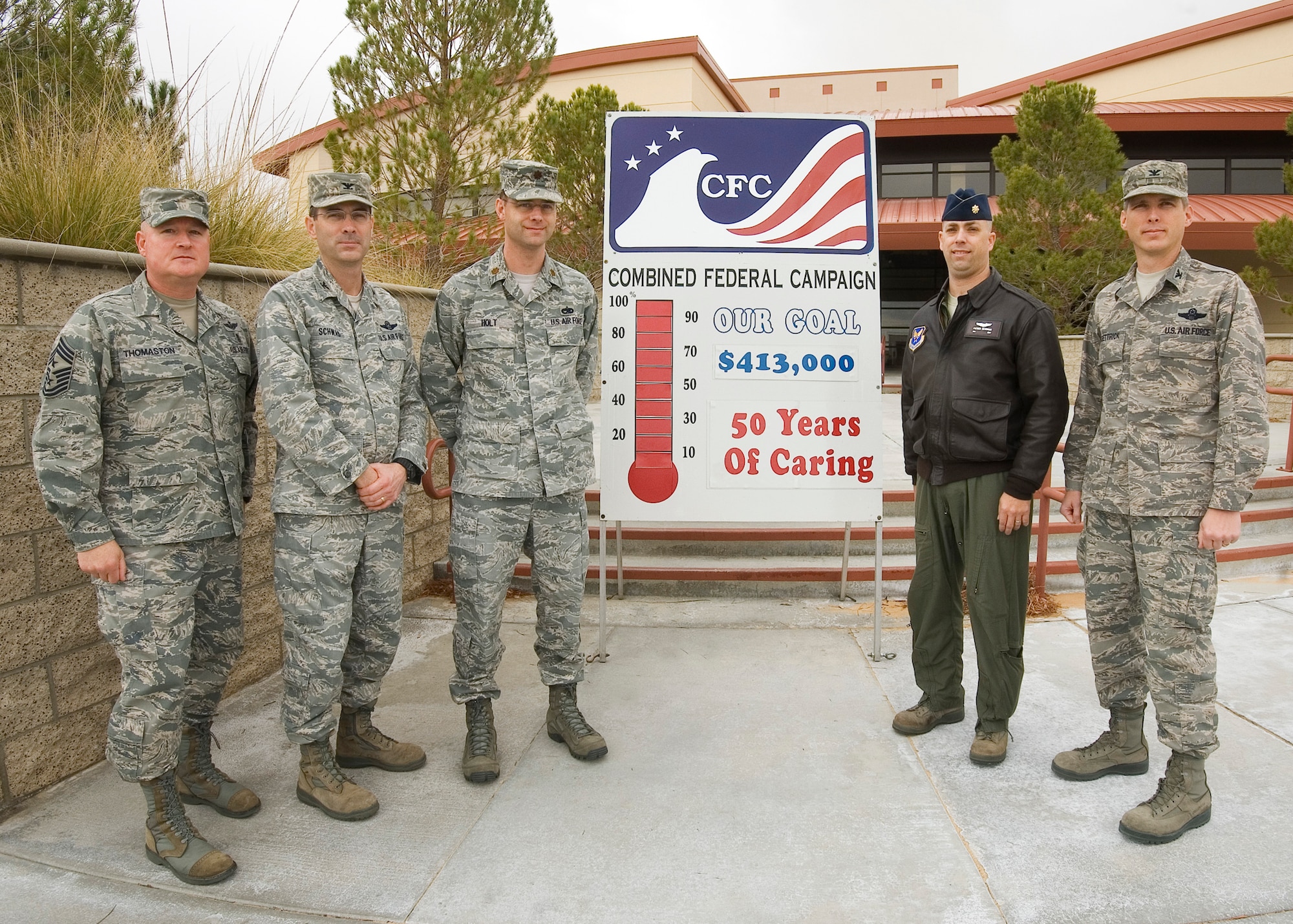 From left: Chief Master Sgt. Bill Thomaston, 95th Air Base Wing command chief; Col. Greg Schwab, 95th ABW commander; Maj. Chad Holt, Air Force Operational Test and Evaluation Center Detachment 5; Maj. Patrick Merriman, AFOTEC Det. 5 and Col. Garvin McGettrick, AFOTEC Det. 5 commander, pose in front of Bldg. 3000 with a sign showing this year's Combined Federal Campaign goal for the base.  Team Edwards exceeded its goal by 121%. The base raised $500,927.36. Final donations were turned in Dec. 15. (Air Force photo by Rob Densmore)