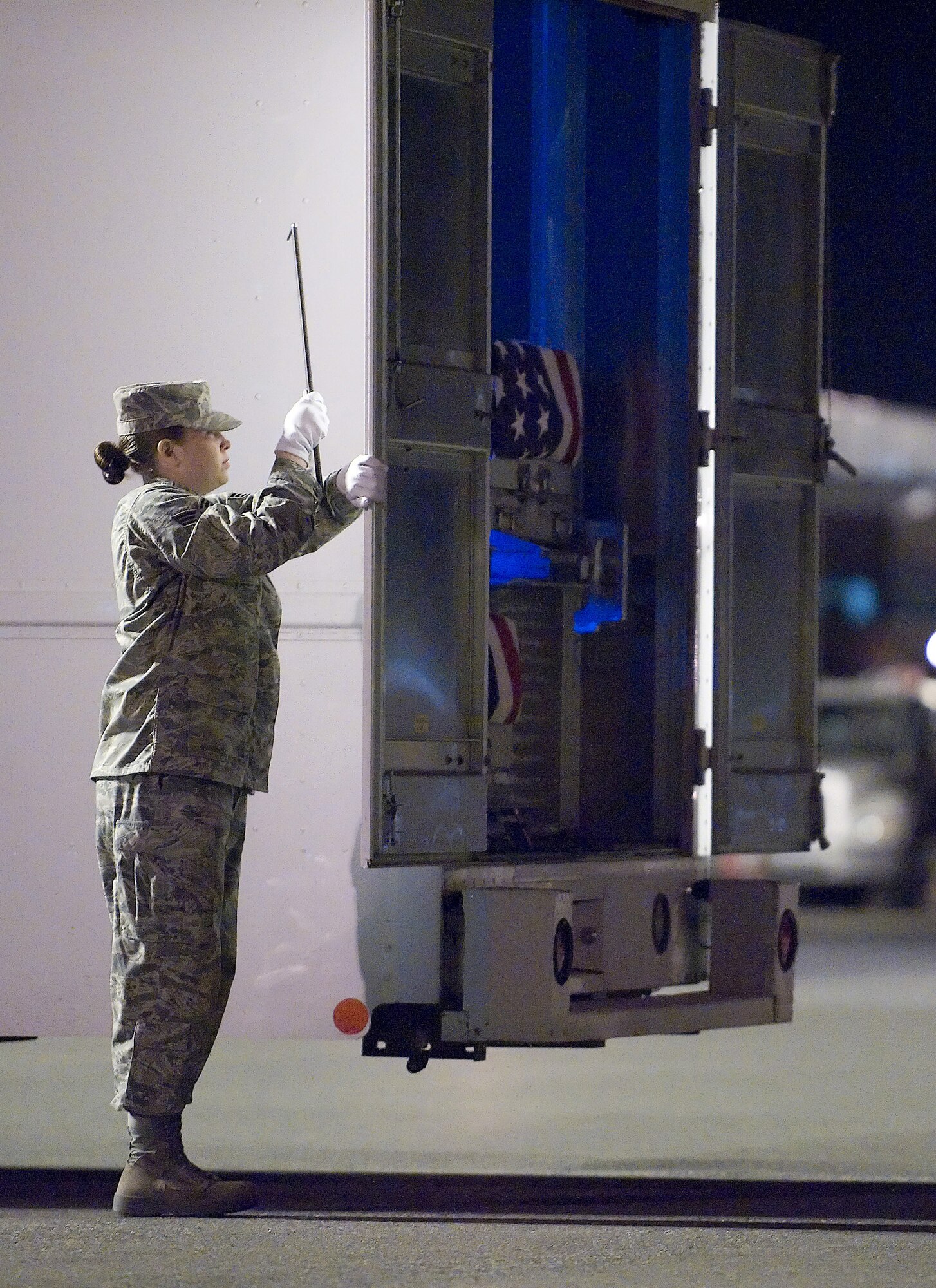 Senior Airman Kayla Penn, a services journeyman assigned to the 302nd Force Support Squadron, served as a vehicle transfer guide in support of the Air Force Mortuary Affairs Operation at Dover Air Force Base Del.  (U.S. Air Force photo/Steve Kotecki)