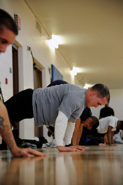 HOLLOMAN AIR FORCE BASE, N.M. -- U.S. Air Force Staff Sgt. Adam Aleywine, 49th Medical Operations Squadron, does an atomic pushup Dec. 9, 2011, during a TRX® workout at the Domenici Fitness and Sports Center. The TRX® is an industrial-grade harness of soft nylon webbing and it allows users to safely suspend their bodies and employs the user's bodyweight in a variety of positions and at different resistances, which creates a total-body work out that delivers strength, flexibility and core stability all at once. (U.S. Air Force photo by Airman 1st Class Siuta B. Ika/ Released)