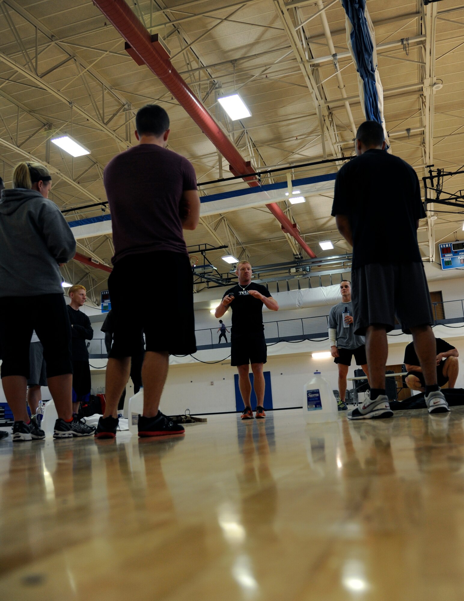 HOLLOMAN AIR FORCE BASE, N.M. -- Jody Morgan, TRX® Force™ Level 1 instructor, talks to members of Team Holloman Dec. 9, 2011, during a workout at the Domenici Fitness and Sports Center. The TRX® itself weighs less than a combat boot, can be used in an area smaller than a parking space and be carried in a duffel bag or ruck-sack. (U.S. Air Force photo by Airman 1st Class Siuta B. Ika/ Released)
