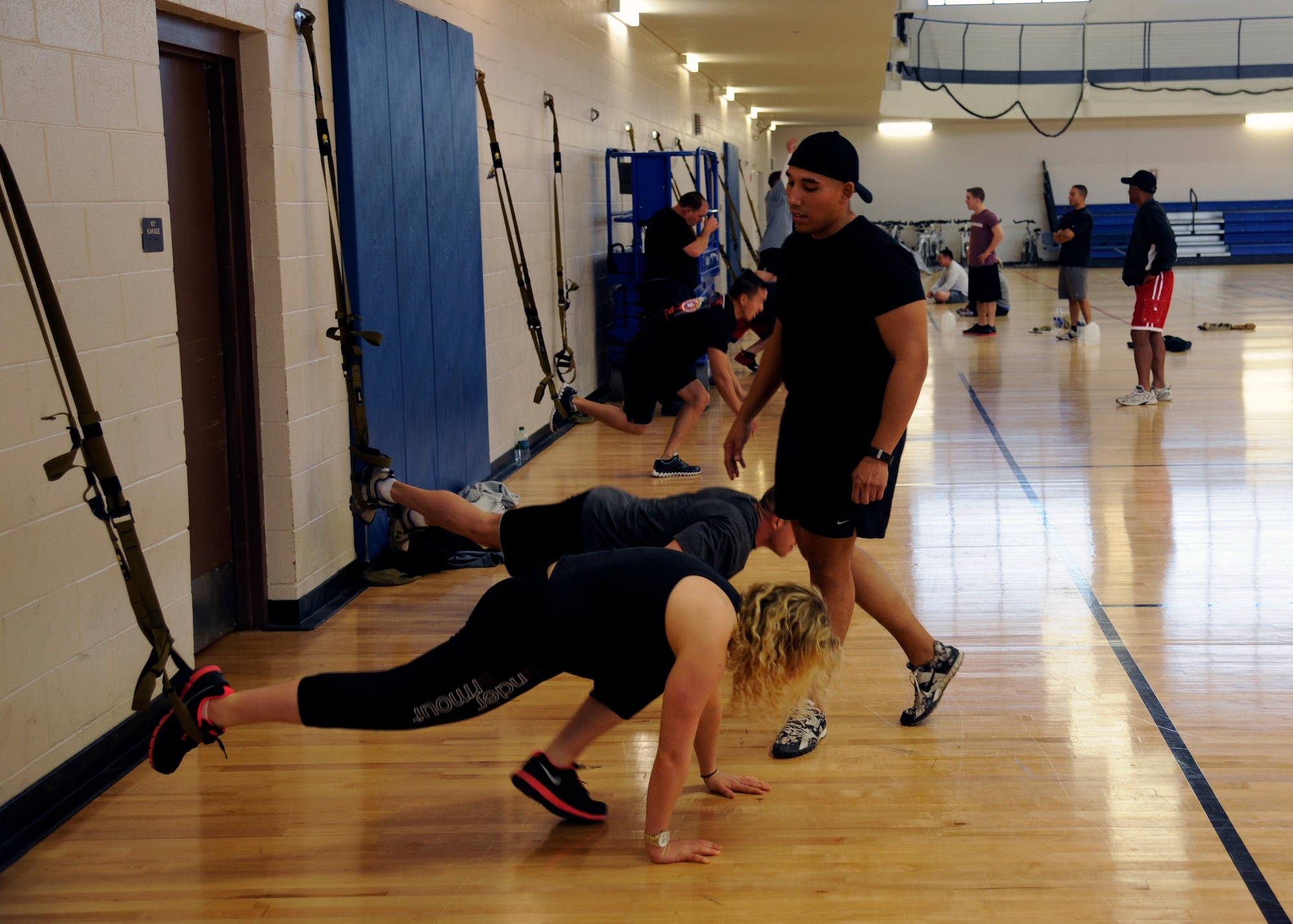 HOLLOMAN AIR FORCE BASE, N.M. -- Mari Mosteller, 49th Wing Public Affairs, does a burpee on one leg, Dec. 9, 2011, during a TRX® workout at the Domenici Fitness and Sports Center. The TRX® is an industrial-grade harness of soft nylon webbing and it allows users to safely suspend their bodies and employs the user's bodyweight in a variety of positions and at different resistances, which creates a total-body work out that delivers strength, flexibility, and core stability all at once. (U.S. Air Force photo by Airman 1st Class Siuta B. Ika/ Released)