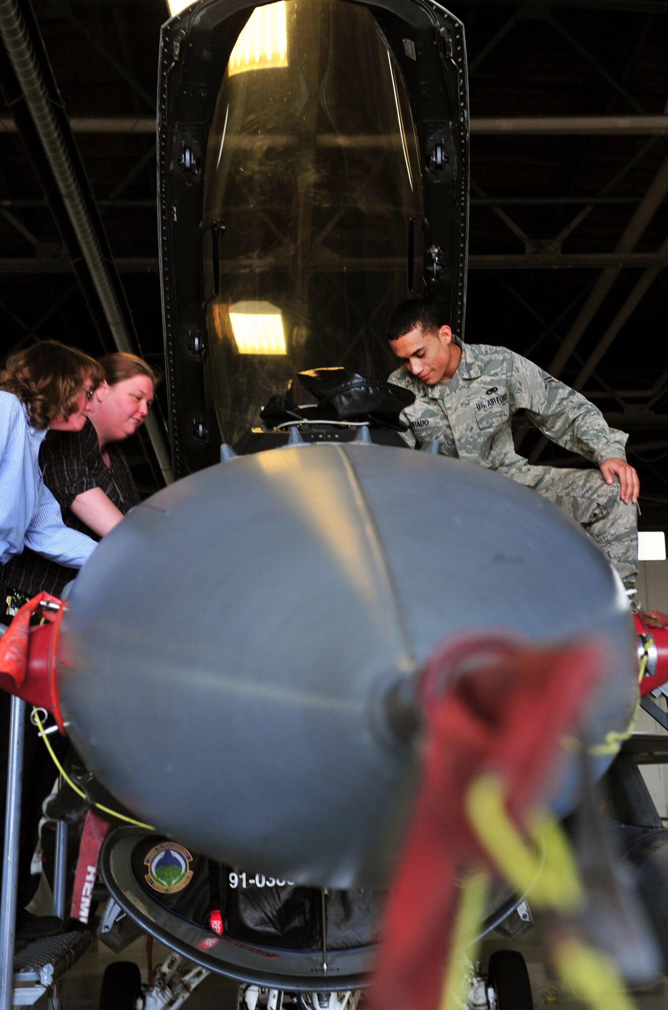 U.S. Air Force Airman 1st Class Blair Tirado, 20th Maintenance Operations Squadron weapons load crew, shows Amanda Skelton, Restoration Advisory Board member, and Jean Chytil, Omaha District U.S. Army Corps of Engineers project geologist, an F-16 Fighting Falcon’s cockpit Dec. 15, 2011, Shaw Air Force Base, S.C. The purpose of the workshop was to educate new community members of the RAB about Shaw’s mission and environmental matters. (U.S. Air Force photo by Senior Airman Amber E. N. Jacobs/Released) 
