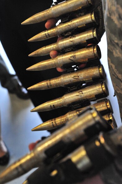 A U.S. Air Force member shows an F-16 Fighting Falcon 20mm round during the Restoration Advisory Board base tour Dec. 15, 2011, Shaw Air Force Base, S.C. The purpose of the workshop was to educate new community members of the RAB about Shaw’s mission and environmental matters. (U.S. Air Force photo by Senior Airman Amber E. N. Jacobs/Released) 