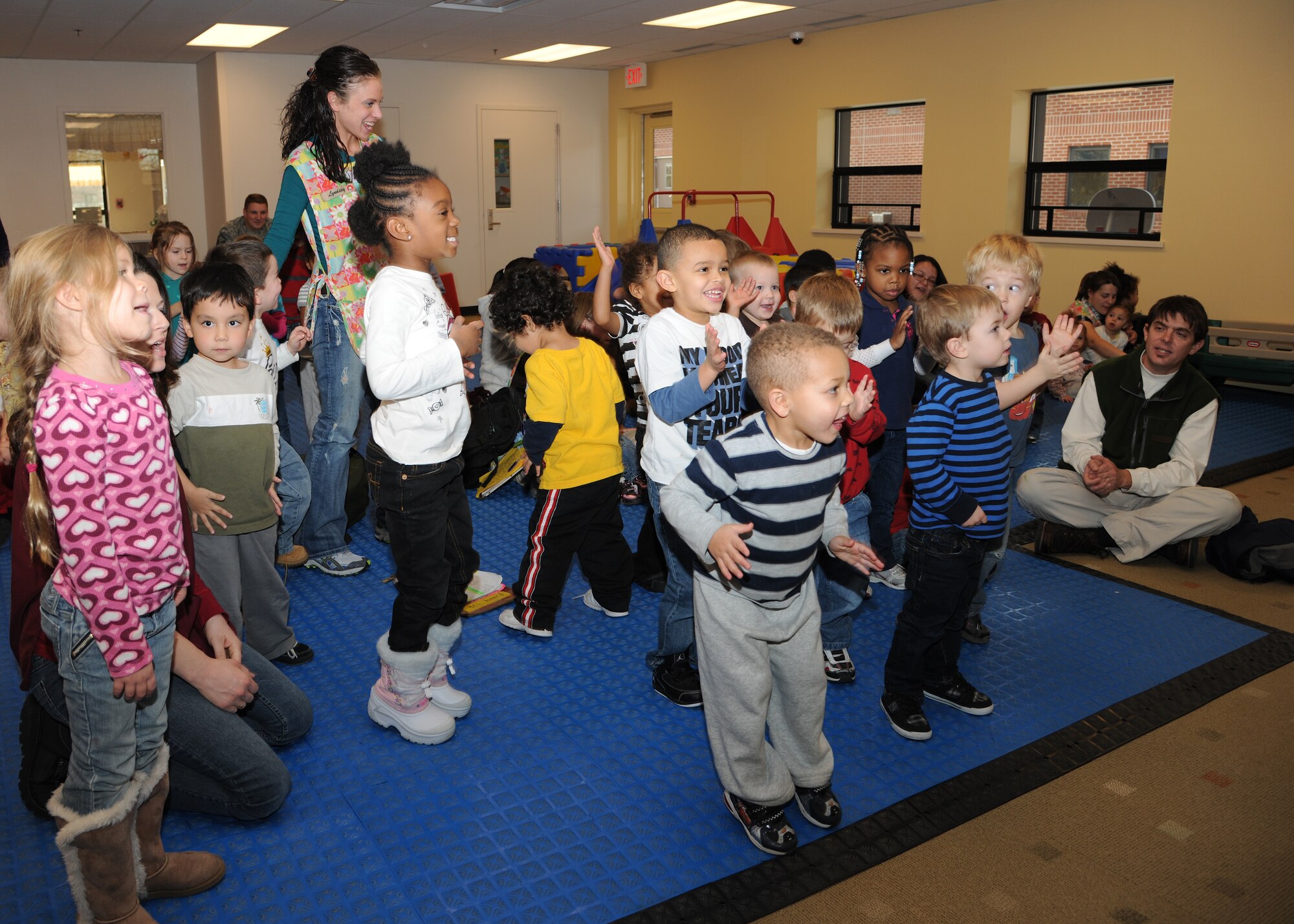 U.S. Air Force members of the Heartland of America Band play for children at the Child Development Center on Dec. 15 at Grand Forks Air Force Base, N.D.  Based out of Offutt Air Force Base, Neb., the band travels to various bases during the holiday season to promote morale amongst Airmen. (U.S. Air Force Photo by Airman 1st Class Ashley N. Taylor) 
