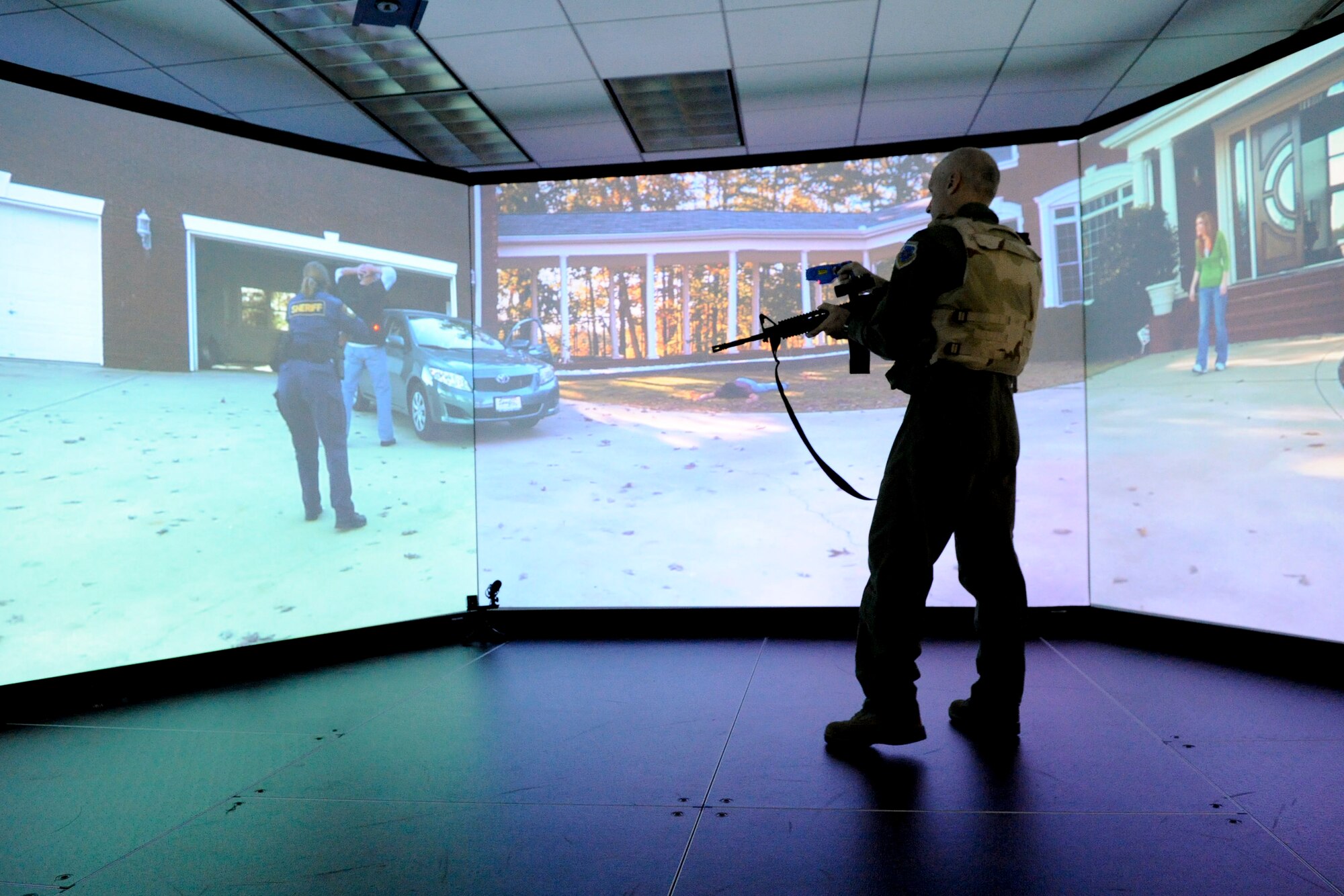 VANDENBERG AIR FORCE BASE, Calif. -- Col. Richard Boltz, the 30th Space Wing commander, tries to talk down an aggressive suspect while testing out the 30th Security Forces Squadron's new firearms training simulator at Combat Arms here Thursday, Dec. 15th, 2011. The new simulator provides a virtual training environment for Vandenberg members to practice real world combat tactics and train with firearms qualification scenarios. (U.S. Air Force/Staff Sgt. Levi Riendeau)