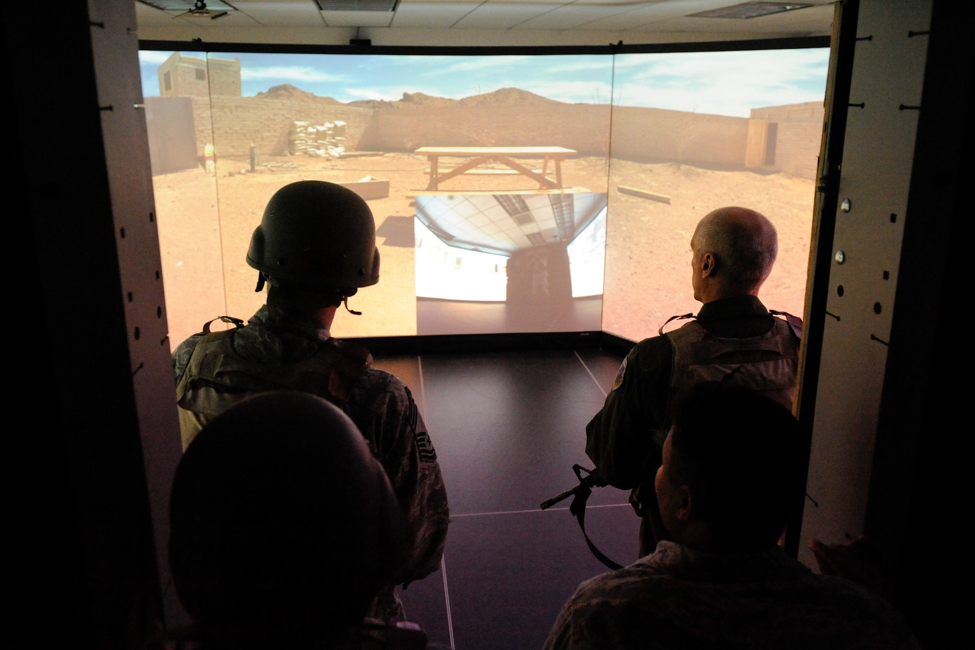 VANDENBERG AIR FORCE BASE, Calif. -- Wing leadership review a training scenario they just completed on the 30th Security Forces Squadron's new firearms training simulator at Combat Arms here Thursday, Dec. 15th, 2011. The new simulator provides a virtual training environment for Vandenberg to can practice real world combat tactics and train with firearms qualification scenarios. (U.S. Air Force/Staff Sgt. Levi Riendeau)