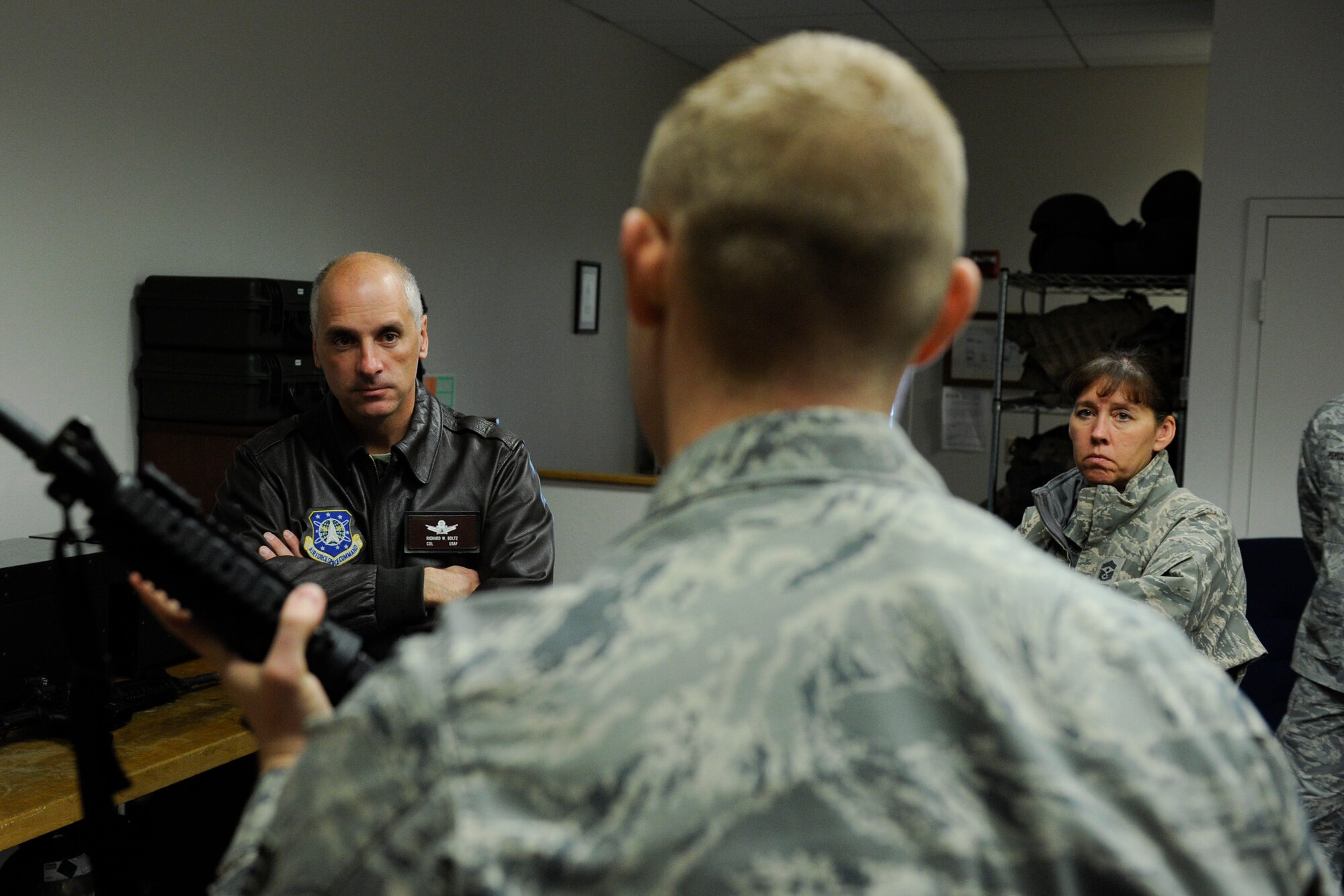 VANDENBERG AIR FORCE BASE, Calif. -- Col. Richard Boltz, the 30th Space Wing commander, and Chief Master Sgt. Suzanne Talbert, the 30th SW command chief, receive a briefing on the 30th Security Forces Squadron's new firearms training simulator at Combat Arms here Thursday, Dec. 15th, 2011. The new simulator provides a virtual training environment for Vandenberg members to practice real world combat tactics and train with firearms qualification scenarios. (U.S. Air Force/Staff Sgt. Levi Riendeau)
