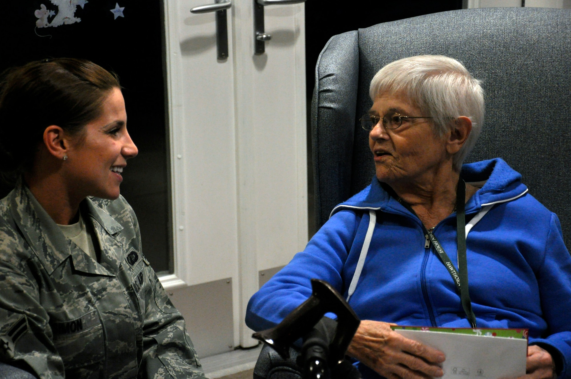 Airman 1st Class Stefanie Simon, 1st Special Operations Contracting Squadron, left, visits with Ruth Hunter, a resident of the Air Force Enlisted Village's Hawthorne House, at the house in Shalimar, Fla., Dec. 13, 2011. Simon and other Hurlburt Field Airmen delivered holiday cards to the widows of the Hawthorne House to spread holiday cheer. (U.S. Air Force photo/Staff Sgt. William Banton)(Released)