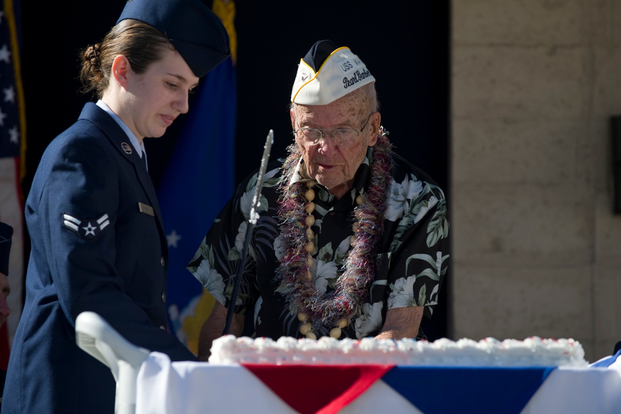 Air Force Technical Applications Center Airman 1st Class Nicole Hart – the most junior servicemember present – and retired U.S. Navy Capt. Jeffrey – the most senior member present – cut the cake with a ceremonial sword during the Pearl Harbor Day Memorial Ceremony Dec. 7 at Patrick Air Force Base. AFTAC paid tribute to Captain Jeffrey and three other U.S. servicemen and several surviving spouses who were all impacted by the 1941 Japanese attacks on Pearl Harbor. (U.S. Air Force photo/Julie Dayringer)