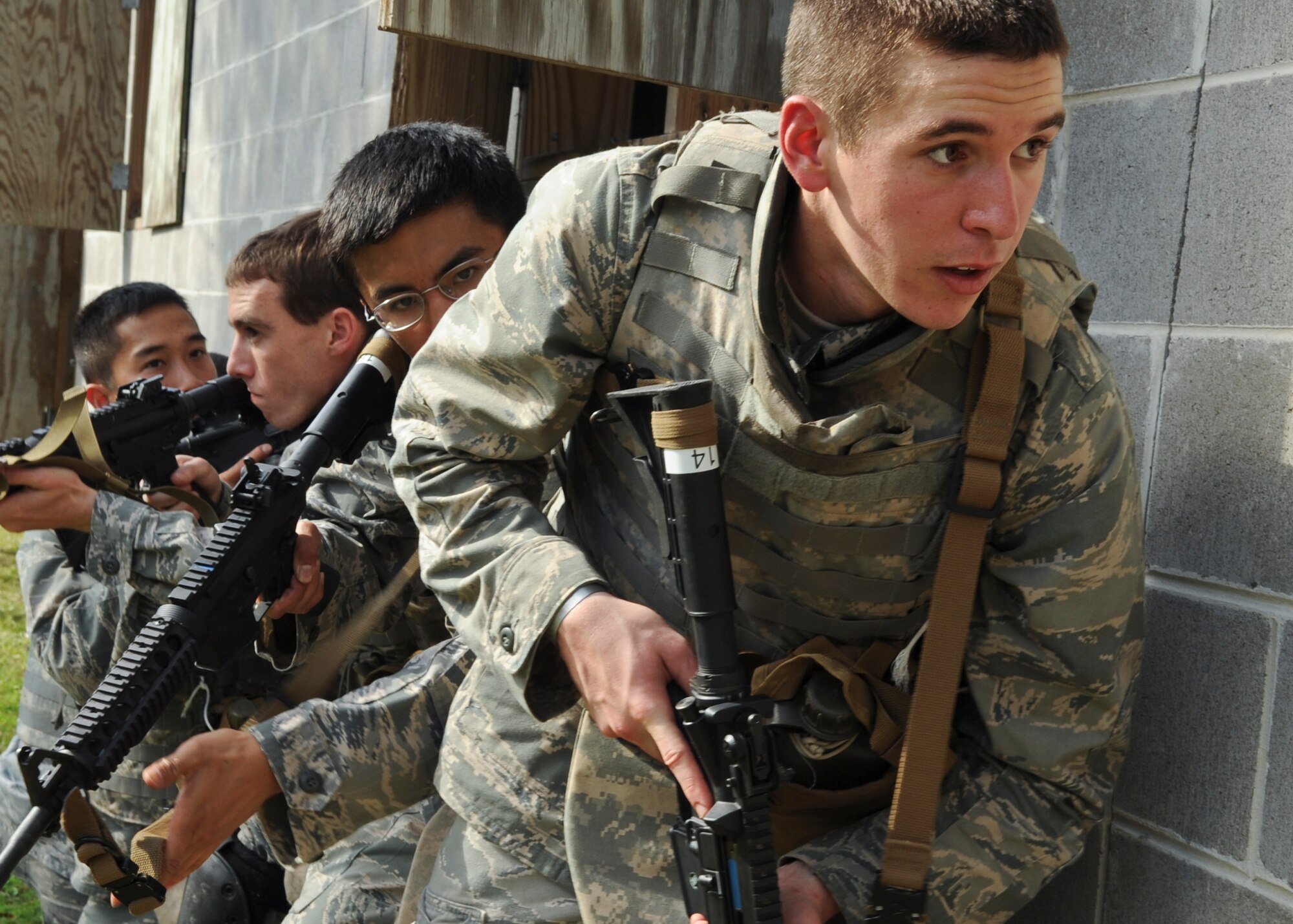 Students in the air liaison officer assessment course prepare to clear a building during the combat portion of an air liaison officer training course at Moody Air Force Base, Ga., Dec. 15, 2011. Trainees were tested on their ability to lead a team and accomplish the mission. (U.S. Air Force photo by Airman 1st Class Olivia Dominique/Released)