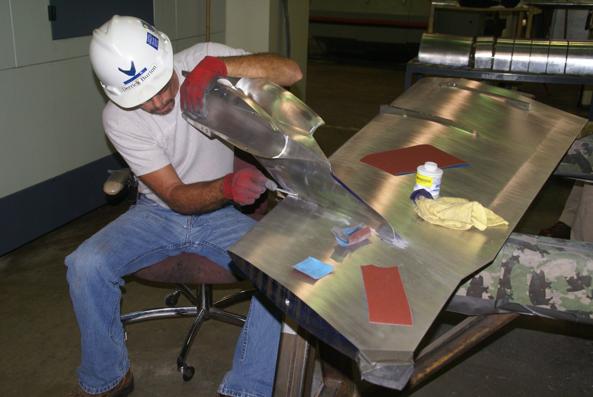 Machinist Derrick Burton hand-works or “blends” around the pod where an engine will be attached to the B-52 model. (Photo by Philip Lorenz)