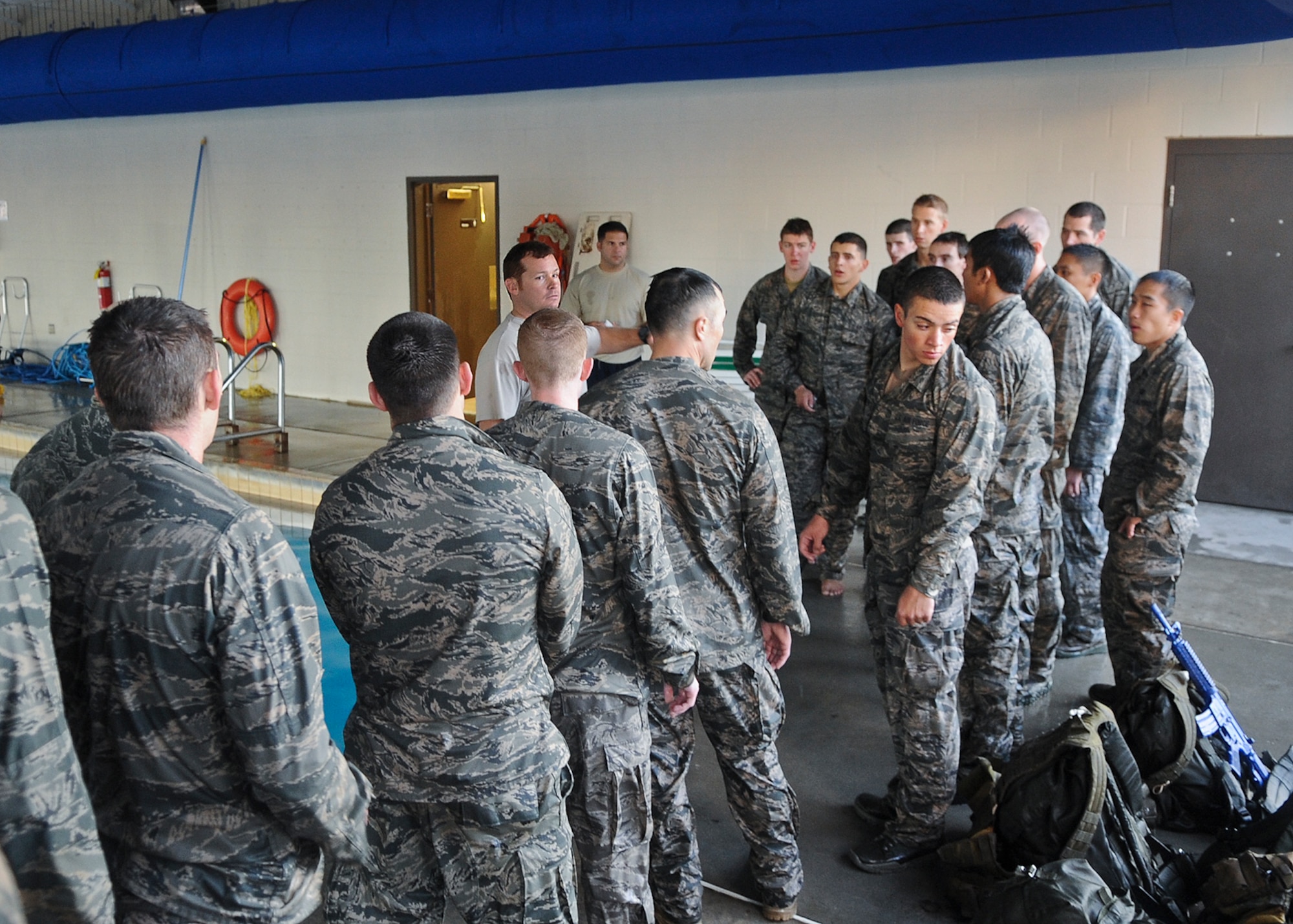 U.S. Air Force Tech. Sgt. Robert Callaway, 93rd Air Ground Operations Wing tactical air control party member, briefs trainees on the next exercise during a water confidence assessment at Moody Air Force Base, Ga., Dec. 14, 2011. The students were kept under constant pressure and given a time limit throughout the assessment to complete certain tasks. (U.S. Air Force photo by Airman 1st Class Olivia Dominique/Released)