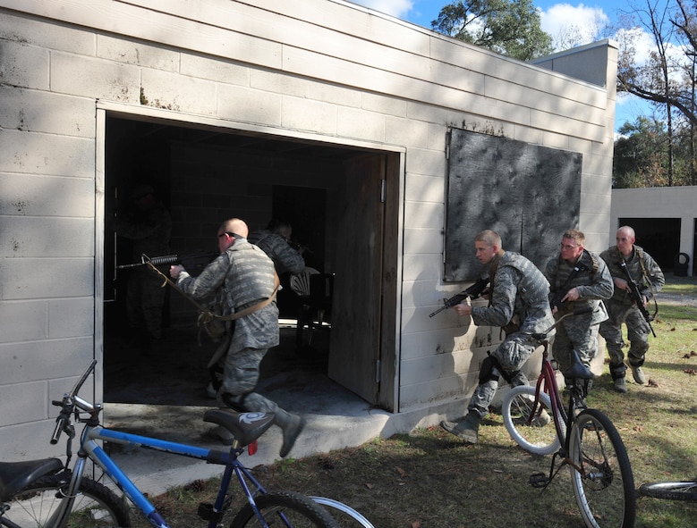 Students going through an air liaison officer assessment course are taught the basics of clearing a building at Moody Air Force Base, Ga., Dec. 15, 2011. The students were later evaluated on accountability of one another, communication and clearing buildings while in a hostile situation.  (U.S. Air Force photo by Staff Sgt. Stephanie Mancha/ Released)   