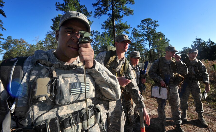 U.S. Air Force  1st Lt. Brandon Pinto, 15th Air Support Operations Squadron, teaches students going through an air liaison officer assessment course an easier way to use a lensatic compass during the practice land navigation portion of the course at Moody Air Force Base, Ga., Dec. 13, 2011. The ALO course is a week-long and has a 45 percent pass rate. Each student is evaluated by his peers, instructors and a review board. (U.S. Air Force photo by Staff Sgt. Stephanie Mancha/Released)