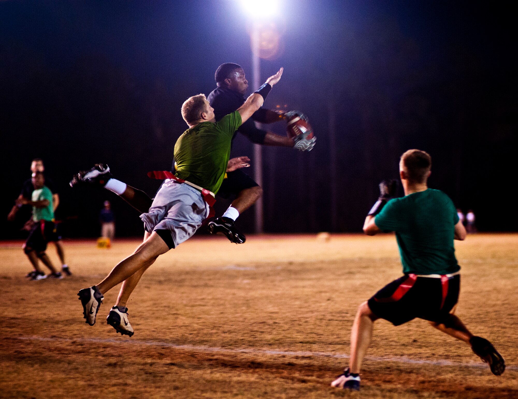 James Baker, the 96th Security Forces Squadron quarterback, scrambles out of the pocket toward a waiting Air Armament Center defender during the base intramural flag football championship game Dec. 15 at Eglin Air Force Base, Fla.  SFS beat the Air Armament Center team 19-14 to claim the title.  It had been three years since they’d been the champs.  (U.S. Air Force photo/Samuel King Jr.)