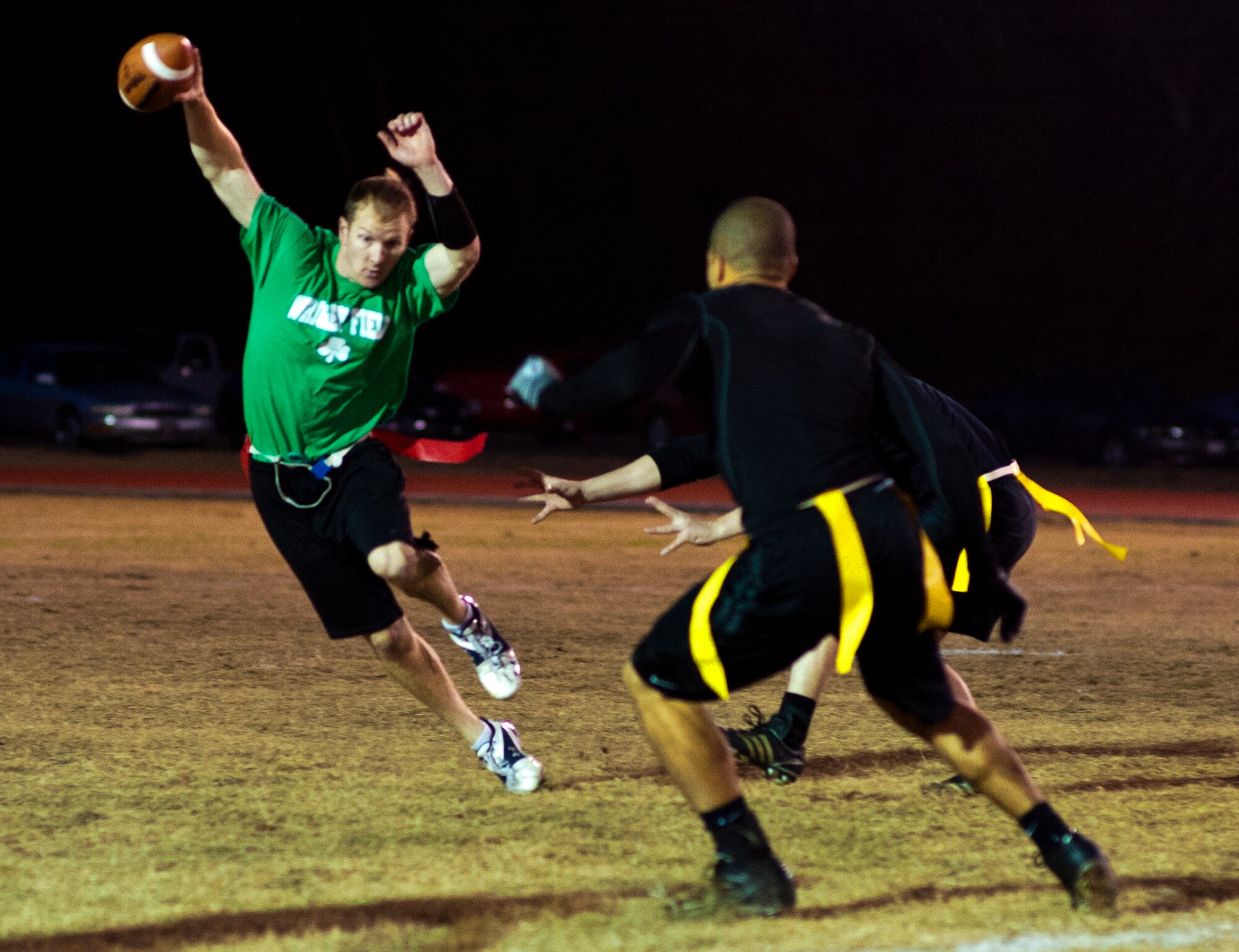 Brian Nagle, the Air Armament Center quarterback, scrambles by a 96th Security Forces Squadron defender during the base intramural flag football championship game Dec. 15 at Eglin Air Force Base, Fla.  SFS beat the Air Armament Center team 19-14 to claim the title.  It had been three years since they’d been the champs.  (U.S. Air Force photo/Samuel King Jr.)