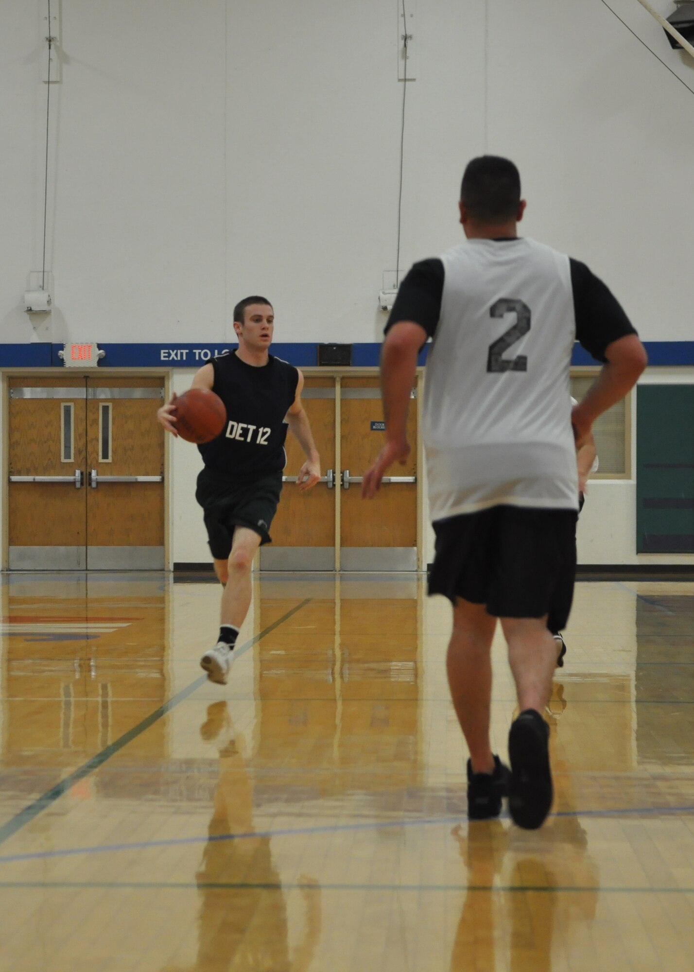 An Airman from the 373rd Training Squadron Det. 12 dribbles down the court during the first game of a four-day intramural basketball tournament Dec. 8, 2011, at Joint Base Lewis-McChord, Wash. The tournament was comprised of eight McChord Field teams. (U.S. Air Force photo/Airman 1st Class Leah Young)