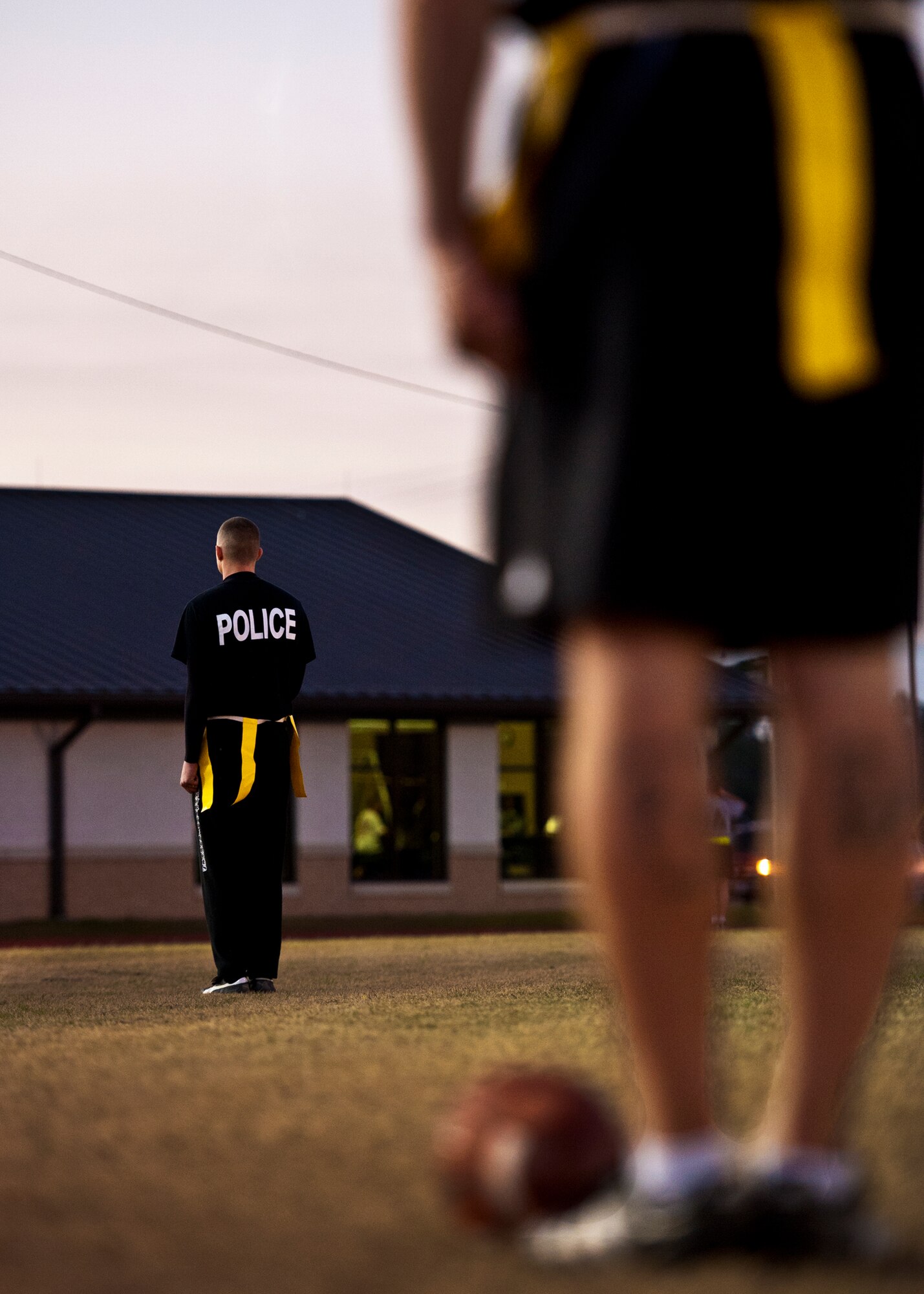 Players from the 96th Security Forces Squadron team stand at attention while retreat is played before the base intramural flag football championship game Dec. 15 at Eglin Air Force Base, Fla.  SFS beat the Air Armament Center team 19-14 to claim the title.  It had been three years since they’d been the champs.  (U.S. Air Force photo/Samuel King Jr.)