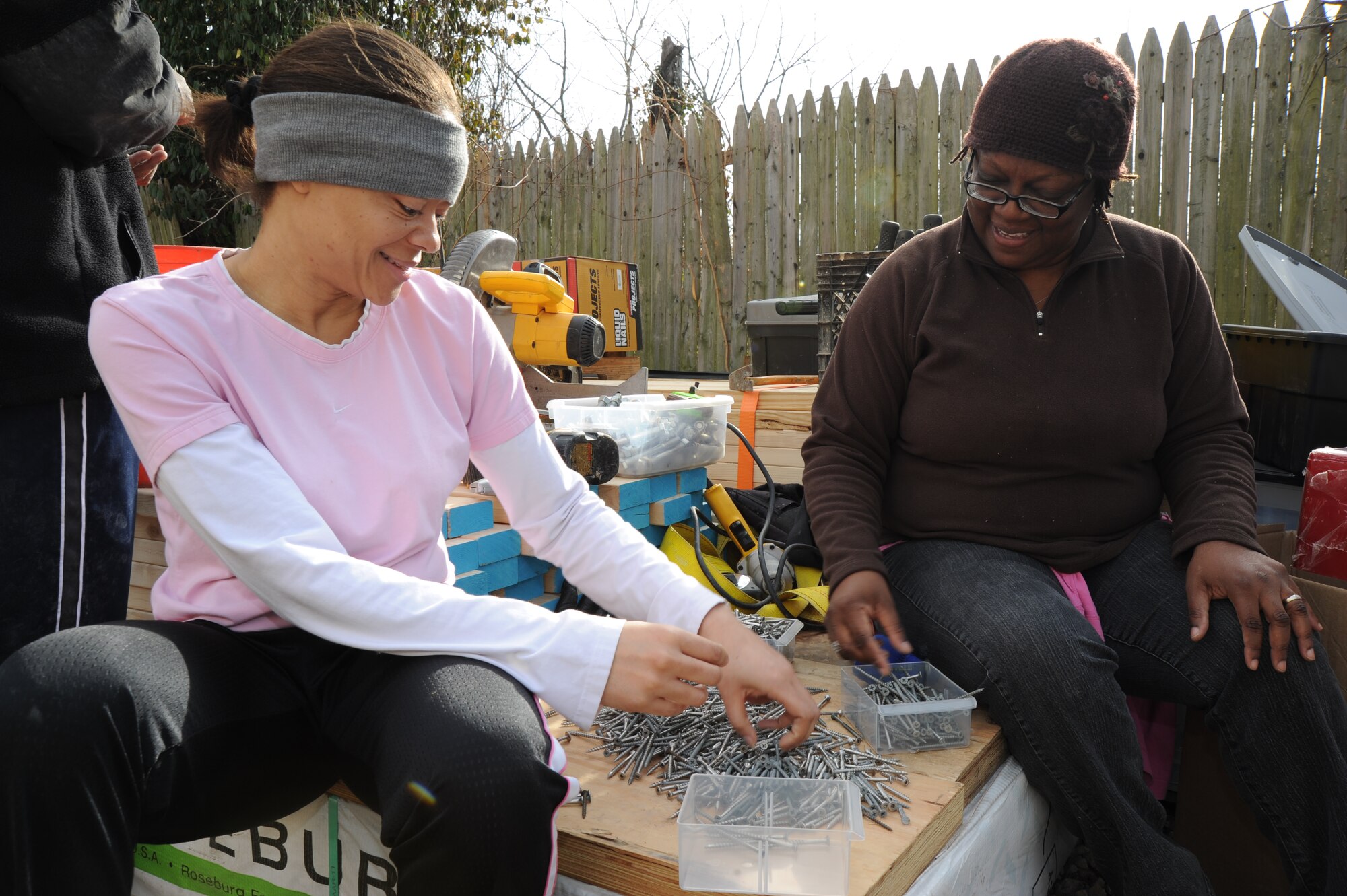 From left to right, Telesha Robinson, Air Force District of Washington information technology specialist, Joint Base Andrews, Md., and Beverly Forbes, 844th Communication Squadron network operations center analyst,, JBA, sort nails Dec. 15 in Washington, D.C. Members from the communications group are contributing more than 140 hours man-hours towards the construction of the first passive home build with Habitat for Humanity in here, which is set to be finished in April. (U.S. Air Force photo by Staff Sgt. Christopher Ruano)