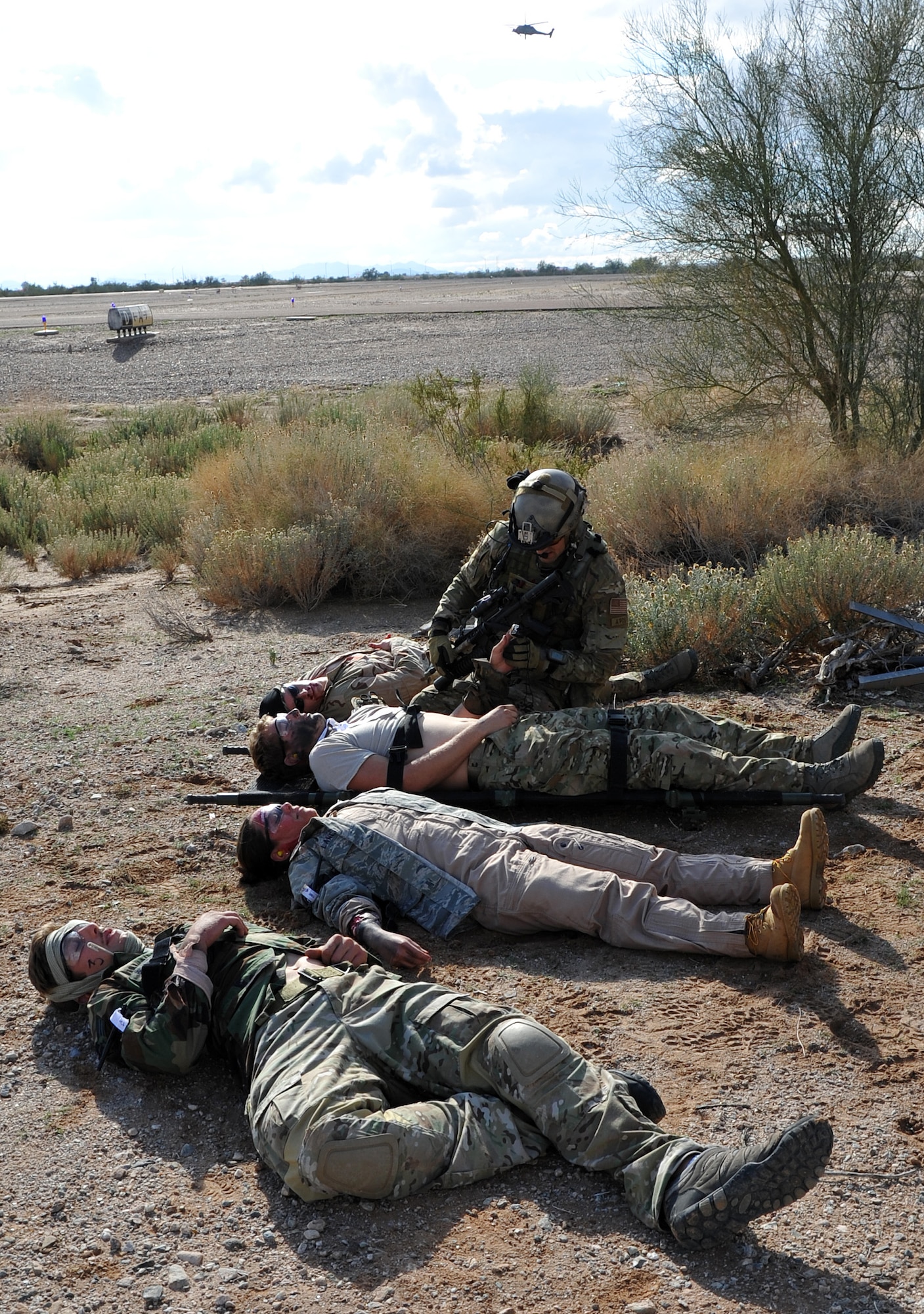 A pararescueman with the 306th Rescue Squadron prepares patients for a medical evacuation during a mass causality drill as part of Operation Shocker. The training exercise put rescue group Airmen in a variety of combat-search scenario to prepare them for a future deployment. (U.S. Air Force Photo/ Master Sgt. Luke Johnson)