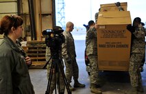 MINOT AIR FORCE BASE, N.D. – Airman 1st Class Geni Oslund, 5th Bomb Wing broadcaster, documents First Sergeants loading donated appliances during Operation Homefront here Dec. 15. Operation Homefront and the Home Depot Foundation in coordination with Minot AFB’s Operation Warmheart and General Electric distributed 135 appliances to Team Minot Airmen and their families affected by the historic Souris River flood. (U.S. Air Force photo/Senior Airman Desiree Esposito)

