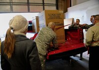 MINOT AIR FORCE BASE, N.D. – Melanie Hoffman, wife of Capt. James Hoffman, 23rd Bomb Squadron, receives appliances donated to her family during Operation Homefront here Dec. 15. Operation Homefront was a charitable initiative headed by the Home Depot Foundation, in coordination with Minot AFB’s Operation Warm Heart and General Electric, which donated more than 130 appliances to Team Minot Airmen and their families affected by the historic Souris River flood. (U.S. Air Force photo/Senior Airman Desiree Esposito)