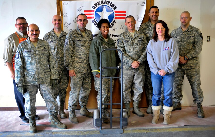 MINOT AIR FORCE BASE, N.D. -- Milt Arneson, Home Depot executive and Amy Palmer, Operation Homefront chief operating officer, pose with the Team Minot First Sergeants who volunteered in support of Operation Homefront here Dec. 15. Operation Homefront was a charitable initiative headed by the Home Depot Foundation, in coordination with Minot AFB’s Operation Warm Heart and General Electric, which donated more than 130 appliances to Team Minot Airmen and their families affected by the historic Souris River flood. (U.S. Air Force photo/Senior Airman Desiree Esposito)