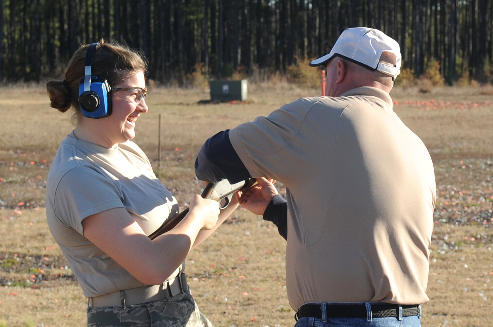 U.S. Air Force Airman 1st Class Faith Bowling, 20th Communications Squadron, prepares to shoot with the help of Tim Godwin, Outdoor Recreation Aide, during her First Term Airman's Course at Shaw Air Force Base, S.C., Dec 13, 2011. The FTAC class is a program in which new Airmen explore what their new base has to offer. (U.S. Air Force photo by Airman First Class Hunter Brady/Released)