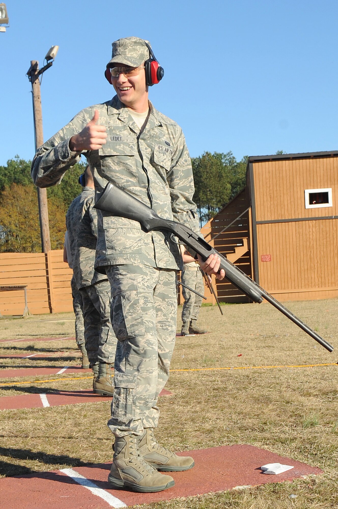 U.S. Air Force Airman 1st Class Nathan Ledet, 20th Communications Squadron, celebrates at the trap and skeet range after a clean shot during his First Term Airman's Course at Shaw Air Force Base, S.C., Dec 13, 2011. The FTAC class is a program in which new Airmen explore what their new base has to offer. (U.S. Air Force photo by Airman First Class Hunter Brady/Released)