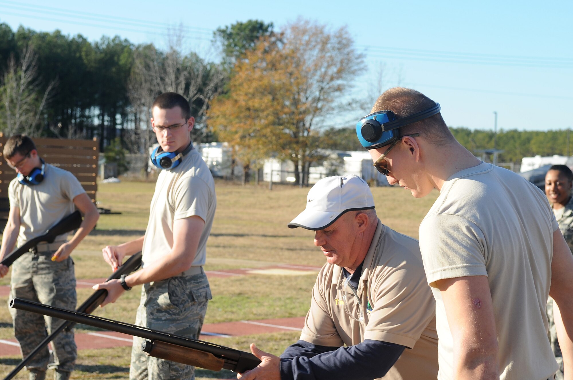 U.S. Air Force Airmen are taught by Tim Godwin, Outdoor Recreation Aide, how to load their weapons during their First Term Airman's Course at Shaw Air Force Base, S.C., Dec 13, 2011. The FTAC class is a program in which new Airmen explore what their new base has to offer. (U.S. Air Force photo by Airman First Class Hunter Brady/Released)