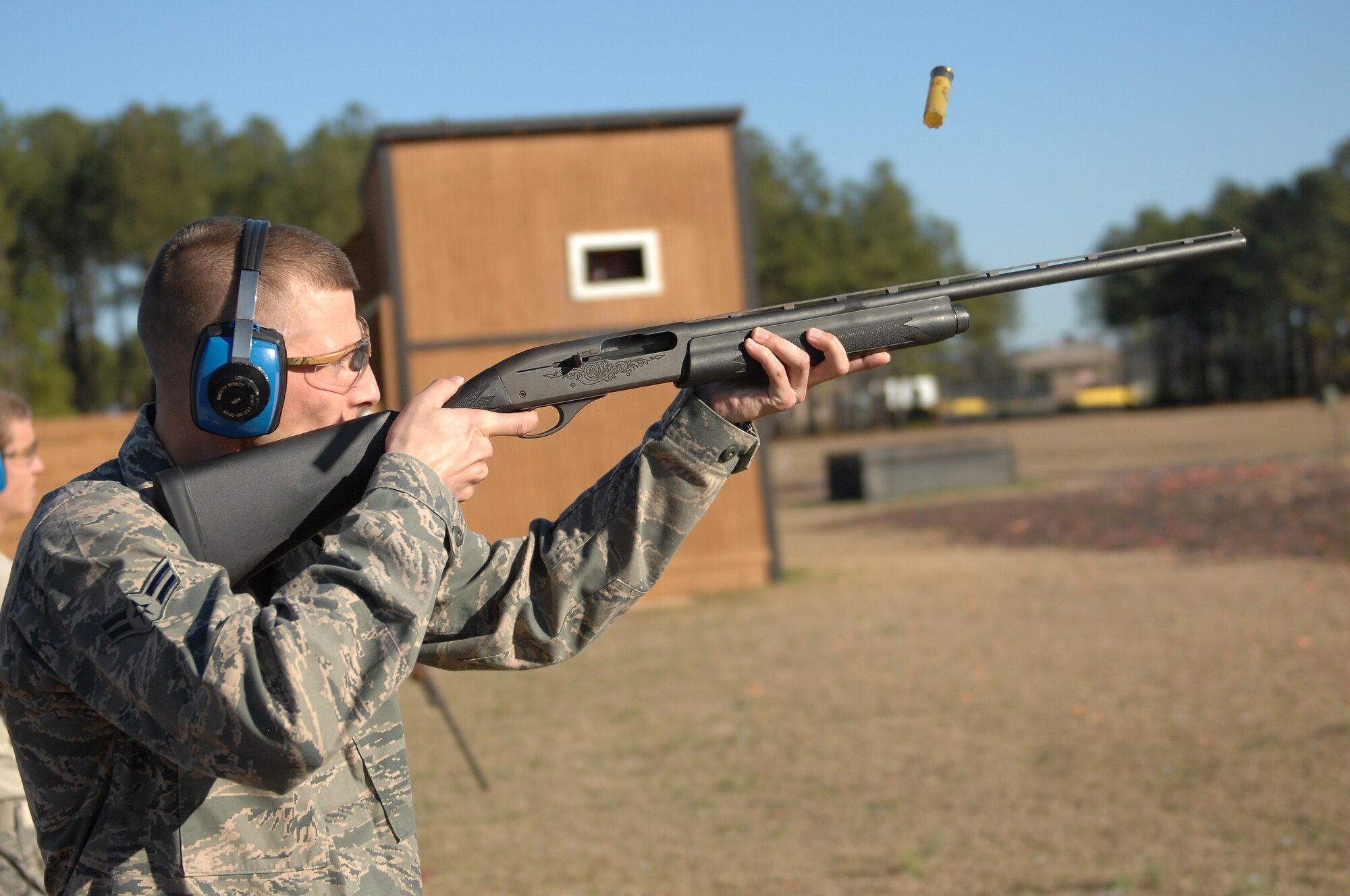 U.S. Air Force Airman 1st Class Joshua Jerome, from the 609th Air Communications Squadron, fires an automatic shotgun downrange in a round of trap shooting during his First Term Airman’s Course at Shaw Air Force Base, S.C., Dec 13, 2011. The FTAC class is a program in which new Airmen explore what their new base has to offer. (U.S. Air Force photo by Airman First Class Blake Hubbard/Released)