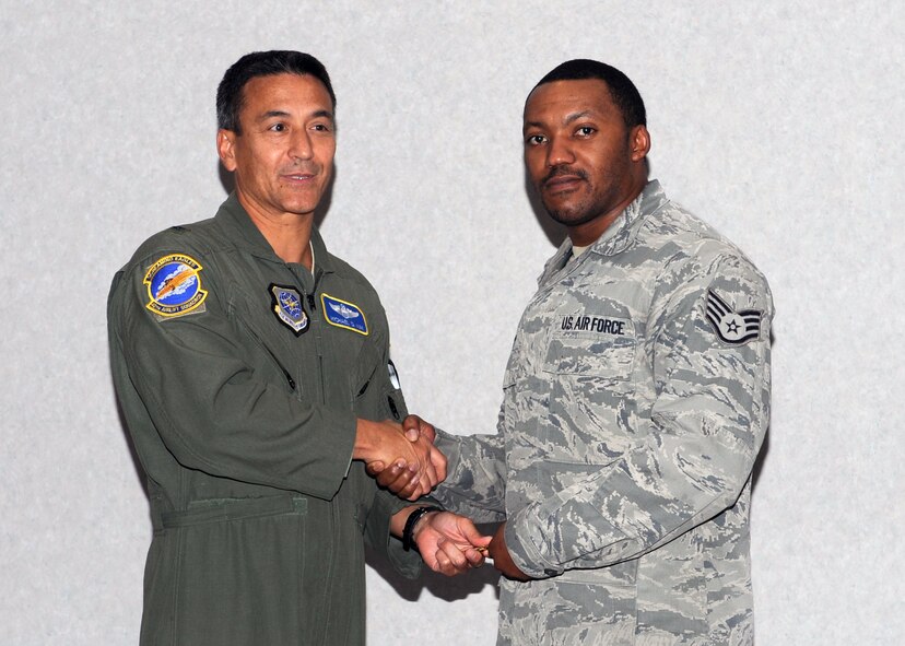 Brig. Gen. Michael Kim, mobilization assistant to the Director of Operations at Scott Air Force Base, Ill. presents the honorary key to Staff Sgt. Reginald Grisby, 317th Aircraft Maintenance Squadron, Dec. 15, 2011, at Dyess Air Base, Texas. The aircraft is the 13th of 28 to be delivered to Dyess by 2013, replacing the current aging fleet of the C-130 Hercules. (U.S. Air Force photo by Airman 1st Class Jonathan Stefanko/ Released)