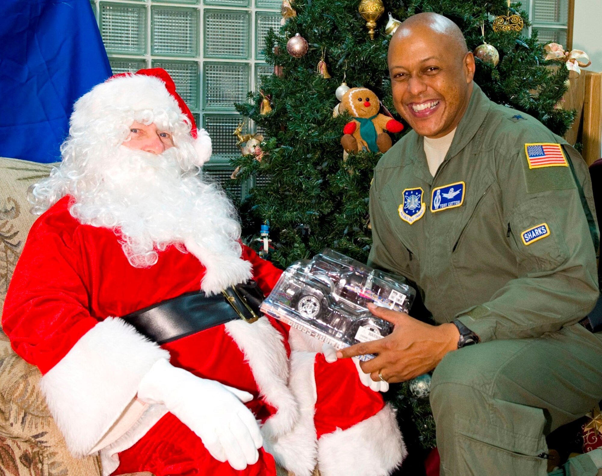 Brig. Gen. Anthony Cotton, 45th Space Wing Commander, gets his Christmas wish from Santa -- a truck -- during the Deployed Family Dinner Dec. 13. The 45th Space Wing Holiday and Post-CUI Party starts at 2 p.m. Friday, Dec. 16, at the Beach House. Wing members and their families are encouraged to attend. (U.S. Air Force photo/Matthew Jurgens)


