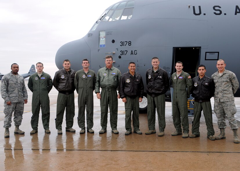 The crew of a new C-130 J-model gathers outside the aircraft Dec. 15, 2011, at Dyess Air Force Base, Texas. The aircraft is the 13th of 28 to be delivered to Dyess by 2013, replacing the current aging fleet of the C-130 Hercules. (U.S. Air Force photo by Airman 1st Class Jonathan Stefanko/ Released)