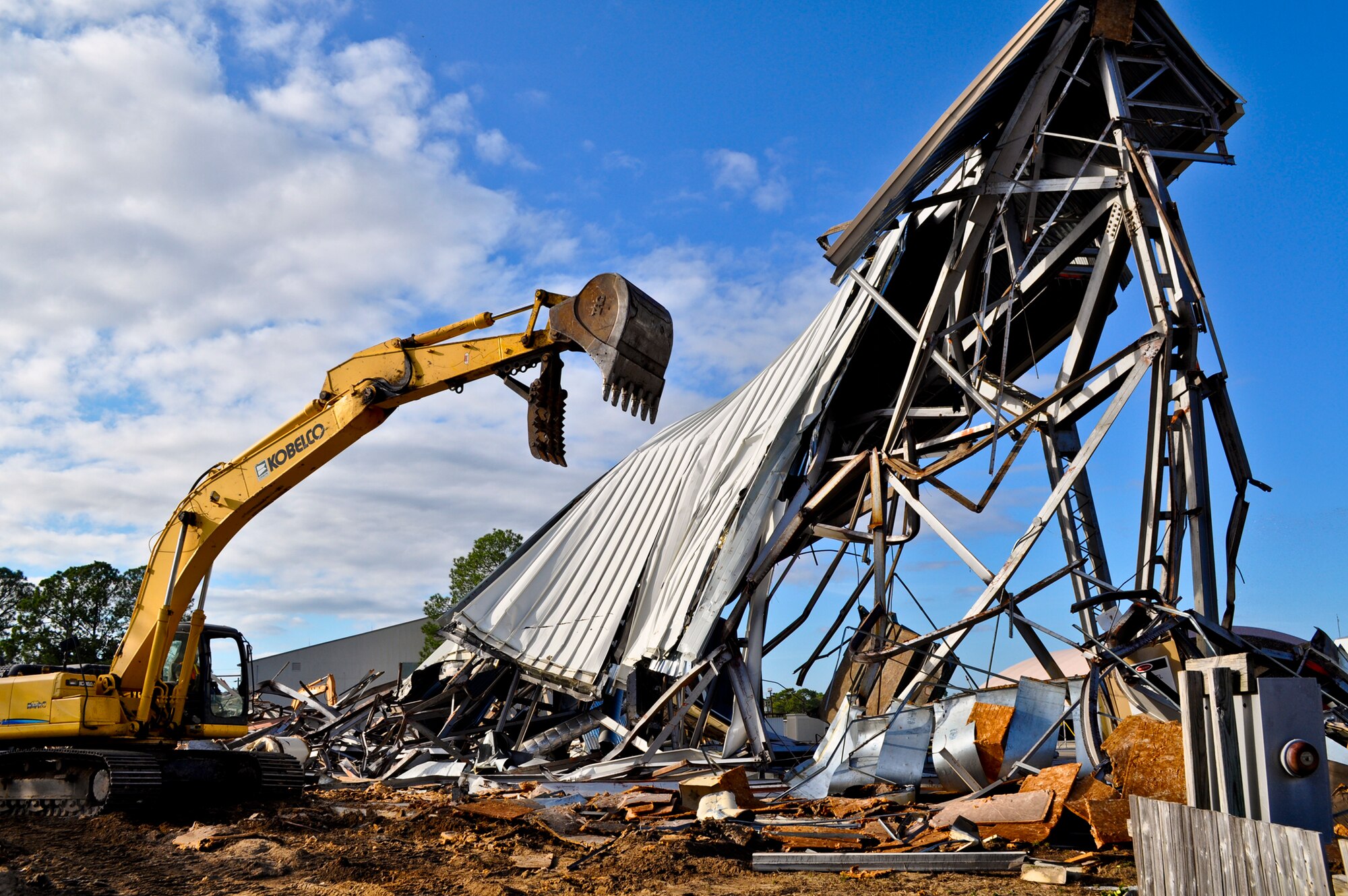 A general contractor team, working in conjunction with the U.S. Army Corp of Engineers and base civil engineers, uses an excavator to demolish a fuel cell maintenance hangar, Dec. 15 at Eglin Air Force Base, Fla.  The hangar was used in the 1960s for B-52s stationed here prior to the 33d Fighter Wing being established. It was used for F-15s until the wing transitioned from Air Combat Command to Air Education and Training Command in October 2009. Replacing it will be an F-35 fuel cell maintenance hangar with three aircraft bays, office space and a tool crib. It is anticipated for completion in Feb. 2013.  (U.S. Air Force photo/Maj. Karen Roganov)
