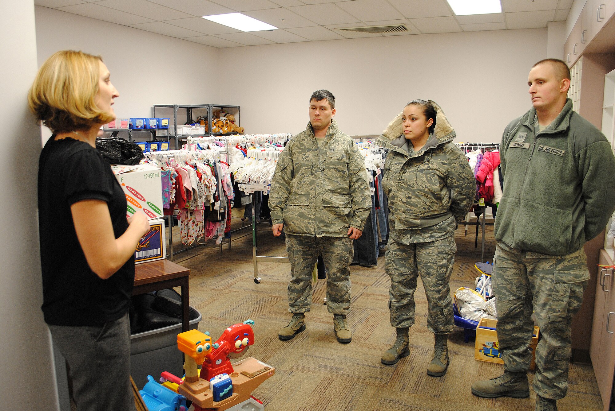 Chris Levine, Child Evaluation Board treasurer, left, speaks to Crespo, Bond and Mumme about the operations of the Child Evaluation Center. The Airmen volunteered to drop off donations to the center Dec. 12. (U.S. Air Force photo/Airman Cortney Paxton)