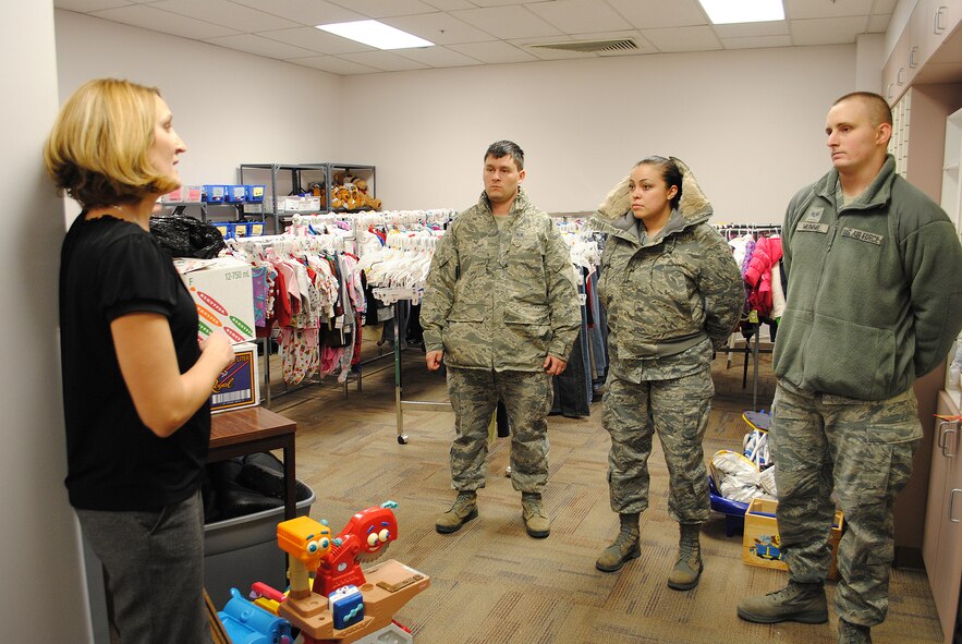Chris Levine, Child Evaluation Board treasurer, left, speaks to Crespo, Bond and Mumme about the operations of the Child Evaluation Center. The Airmen volunteered to drop off donations to the center Dec. 12. (U.S. Air Force photo/Airman Cortney Paxton)