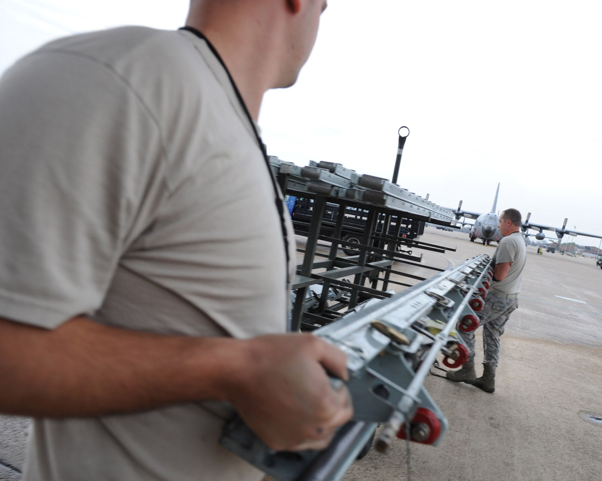Senior Airman James Szelinski, a 314th Aircraft Maintenance Squadron dual rail specialist, and Tech. Sgt. Scott Wright, 314th Aircraft Maintenance Squadron section chief non commissioned officer in charge, load a section of a rail system onto a transport trailer Dec. 16, 2011, at Little Rock Air Force Base, Ark.  Airmen from the 314th AMXS are performing a routine maintenance inspection on the cargo rail system of the Blue Angels C-130T Hercules nicknamed “Fat Albert” and preparing the aircraft for the upcoming air-show season. The Blue Angels will headline the open house and air show at Little Rock AFB scheduled for Sept.  8 and 9. (U.S. Air Force photo by Tech. Sgt. Chad Chisholm)