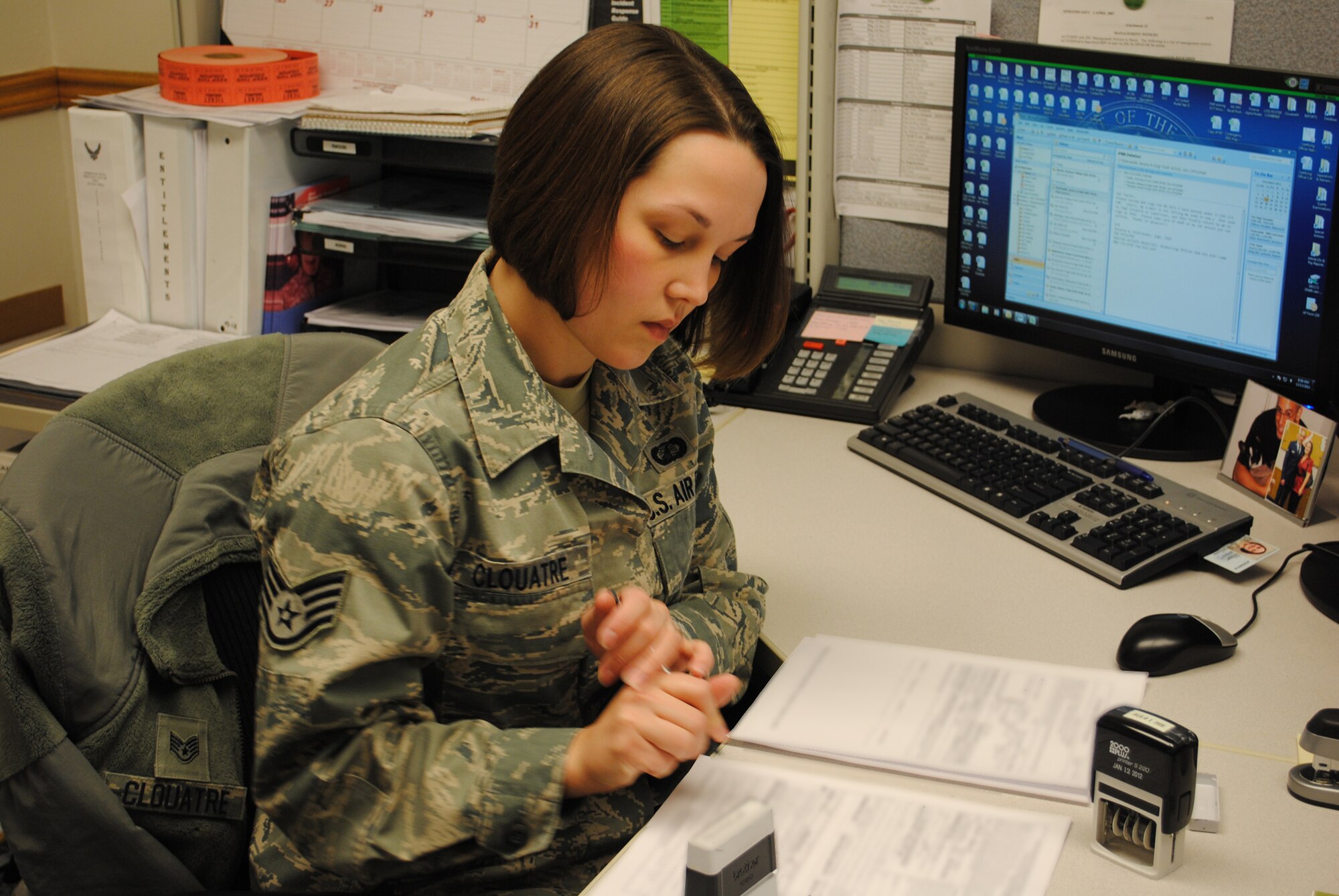 Clouatre works on paperwork at her desk to begin the day. Paperwork and computer work is a big part of her daily duties. (U.S. Air Force photo/Airman Cortney Paxton)