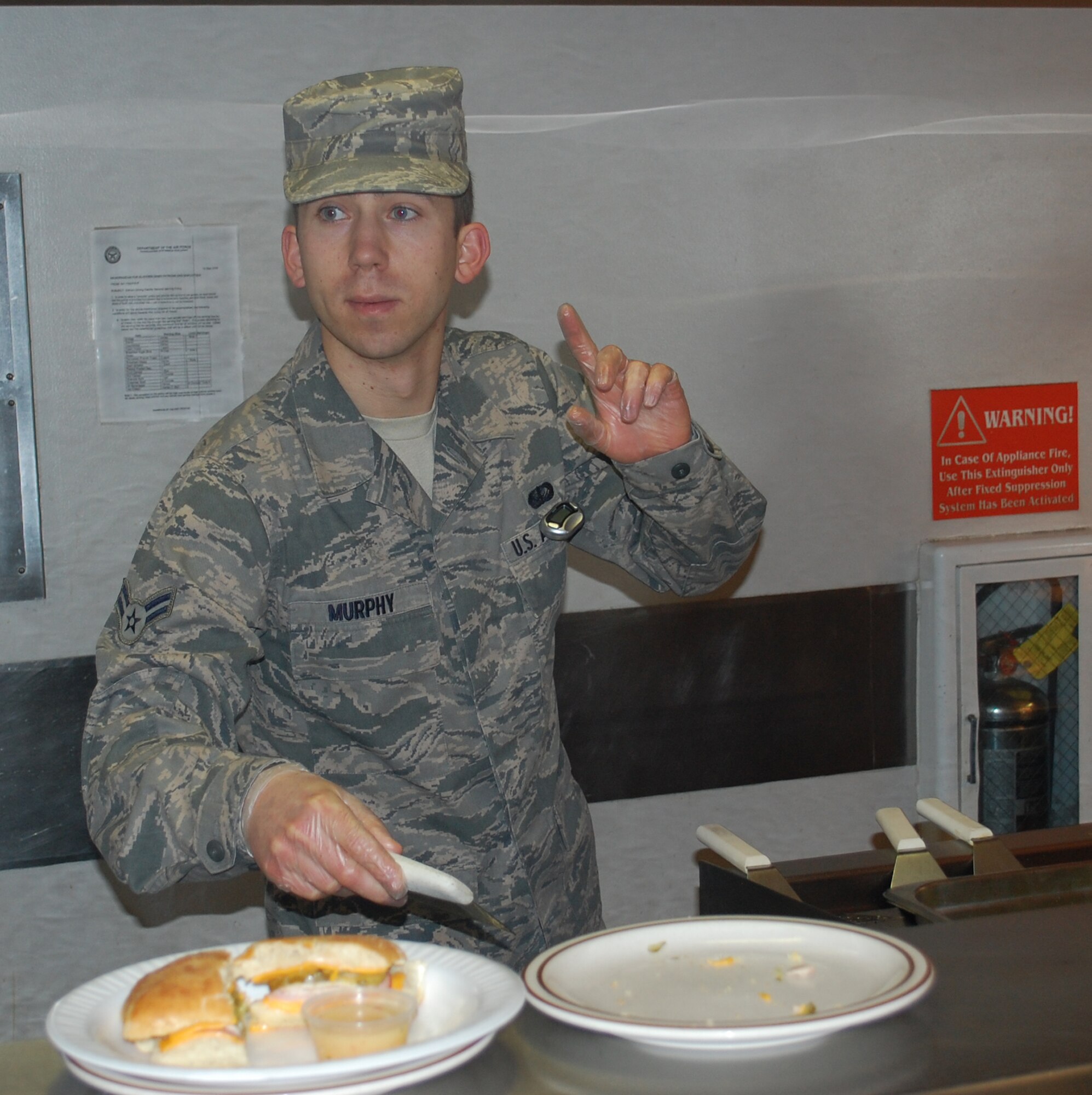 Airman 1st Class Kyle Murphy, 341st Force Support Squadron food apprentice, takes a customer's order. Murphy also was recognized during the inspection and coined by Chief Master Sgt. Richard Rhodes, Air Force Global Strike Command chief functional manager. (U.S. Air Force photo/Senior Airman Reggie Manning)