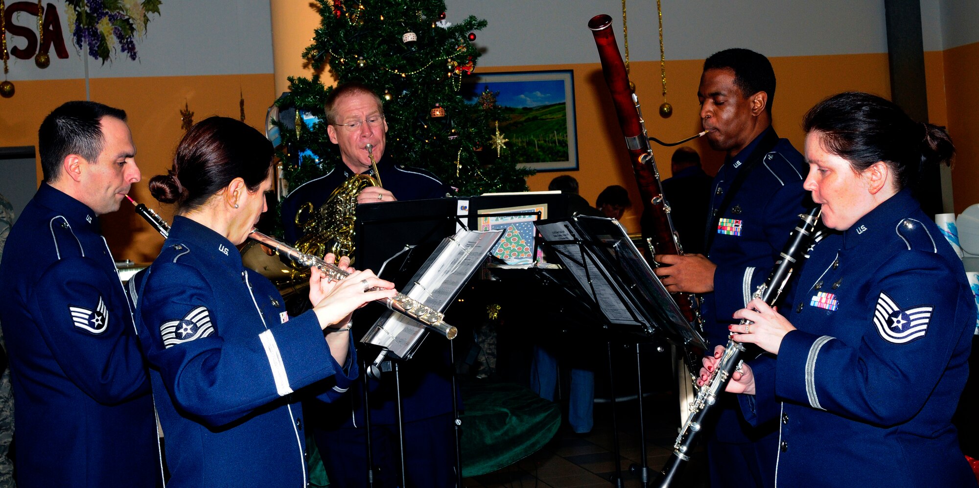 The U.S. Air Forces in Europe Band Winds Aloft Woodwind quintet plays holiday music at the Italian mensa Dec.14 at Aviano Air Base. The ensemble serenaded Team Aviano and local comunity members Dec. 14-16 as part of a community relations tour celebrating the holidays. (U.S. Air Force photo/Airman 1st Class Briana Jones)