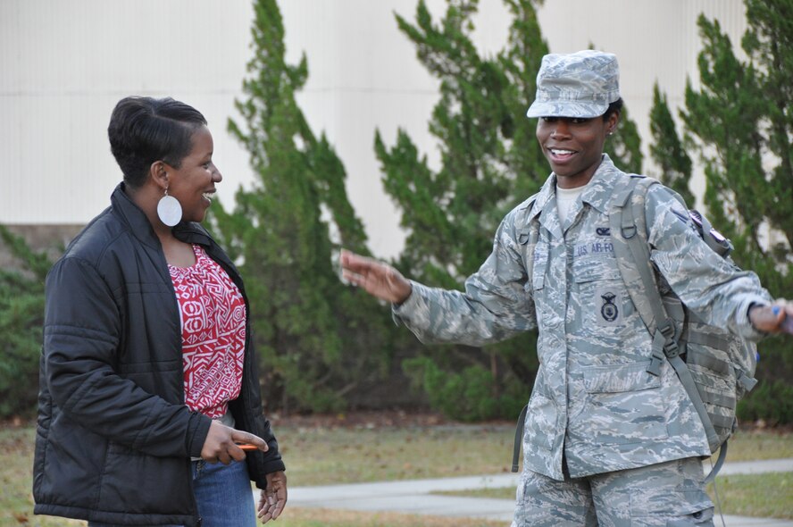 Tech. Sgt. Diane Speas (left) welcomes home Senior Airman Nadia Snider upon her return from Afghanistan. Snider is a member of the 916th Security Forces and spent the last six months overseas. (USAF photo by SSgt. Terrica Jones, 916ARW/PA)